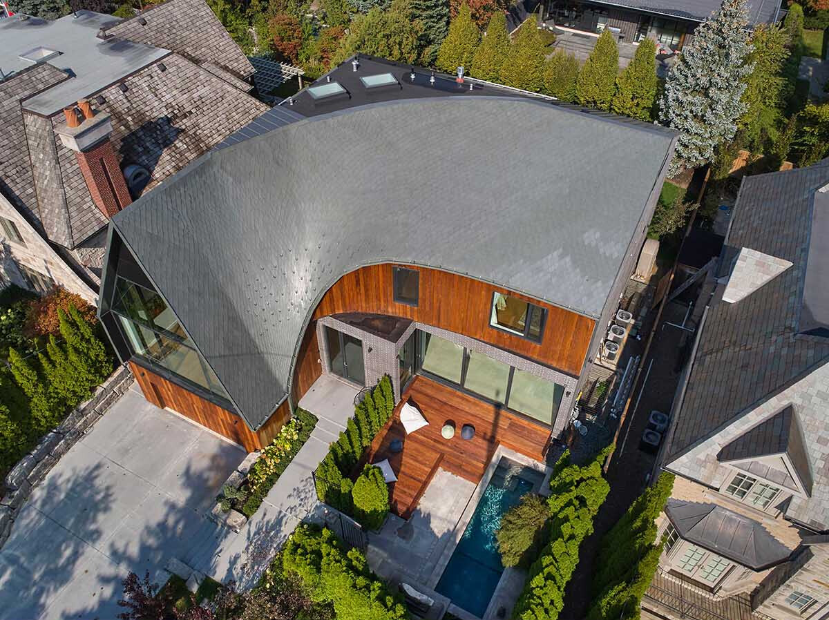 A sculptural roof designed with parametric software creates a flowing silhouette that transforms this Toronto home.