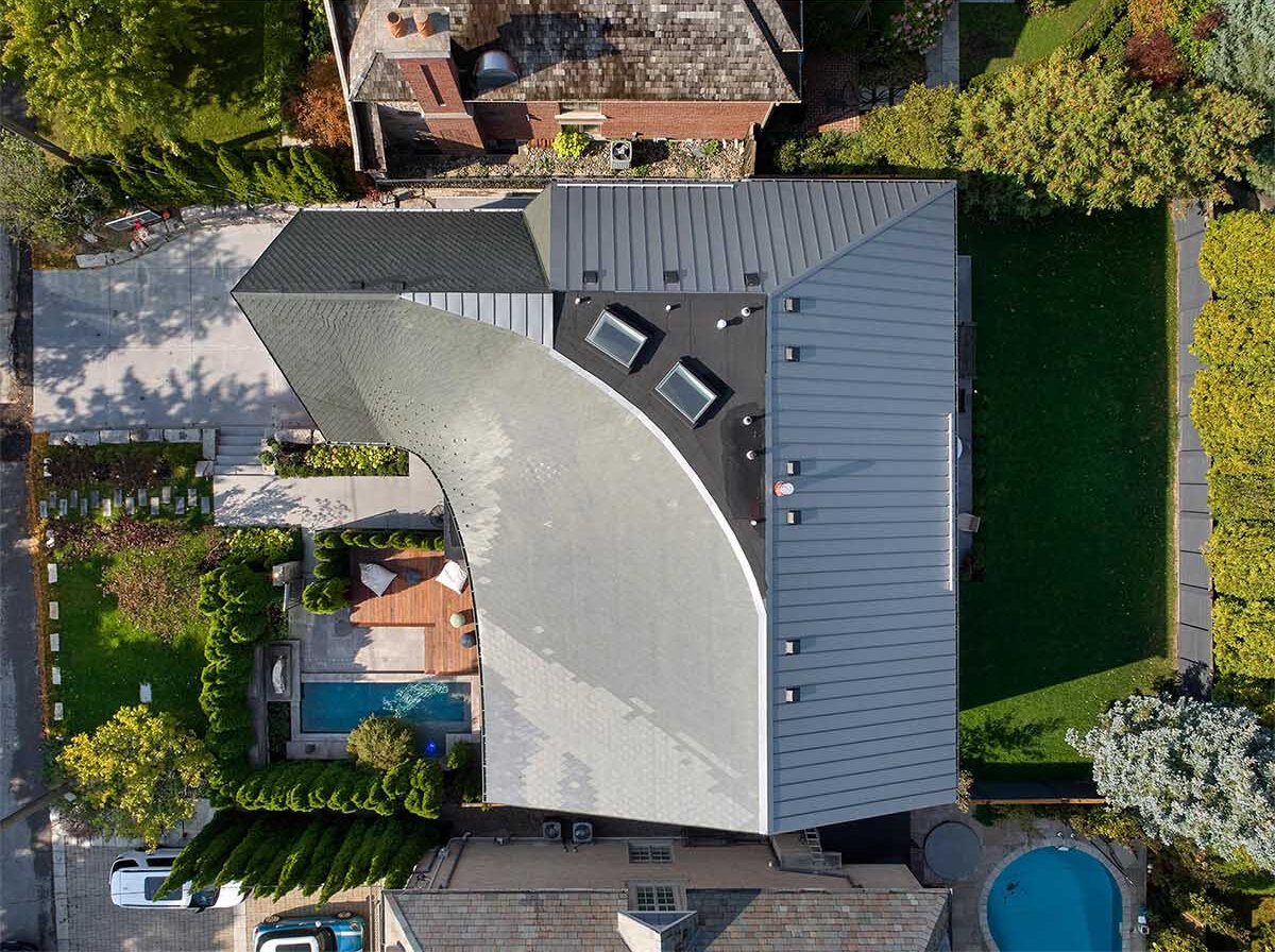 A sculptural roof designed with parametric software creates a flowing silhouette that transforms this Toronto home.
