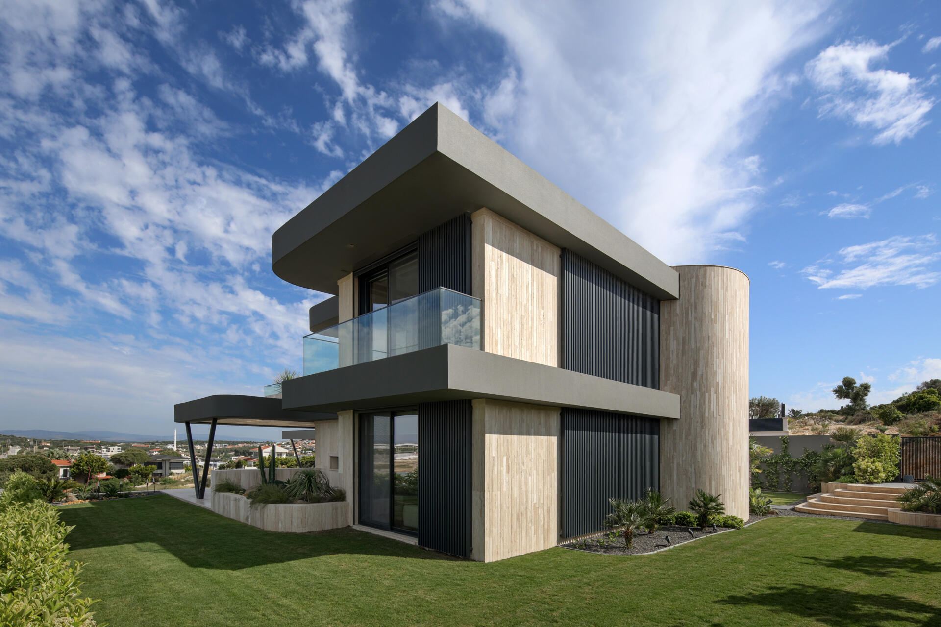 A modern home has wave-inspired architecture with sculptural eaves that create shaded outdoor spaces throughout the day.