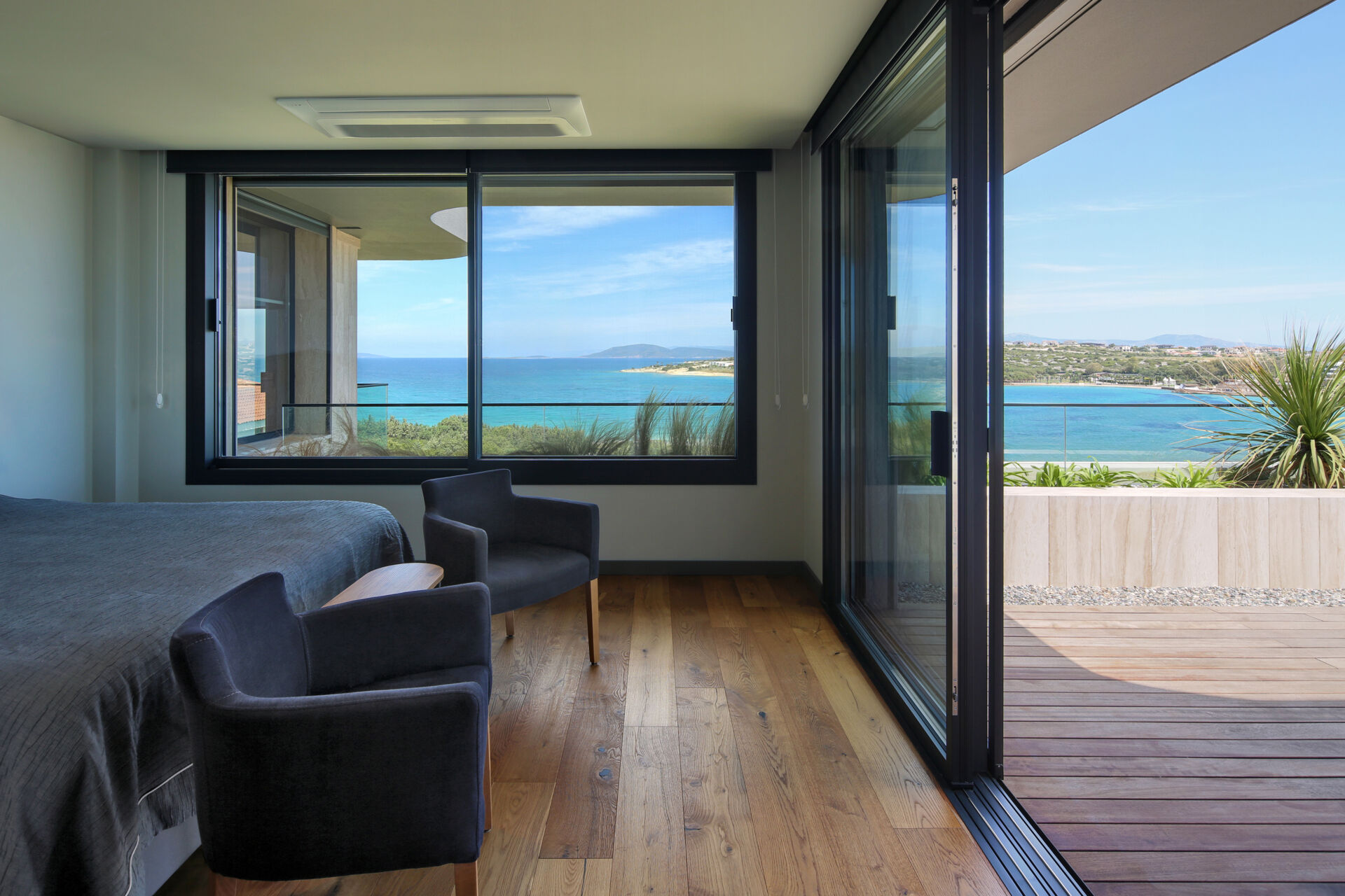 Upper-level bedrooms with private balconies and shared terraces, all oriented toward panoramic sea views.