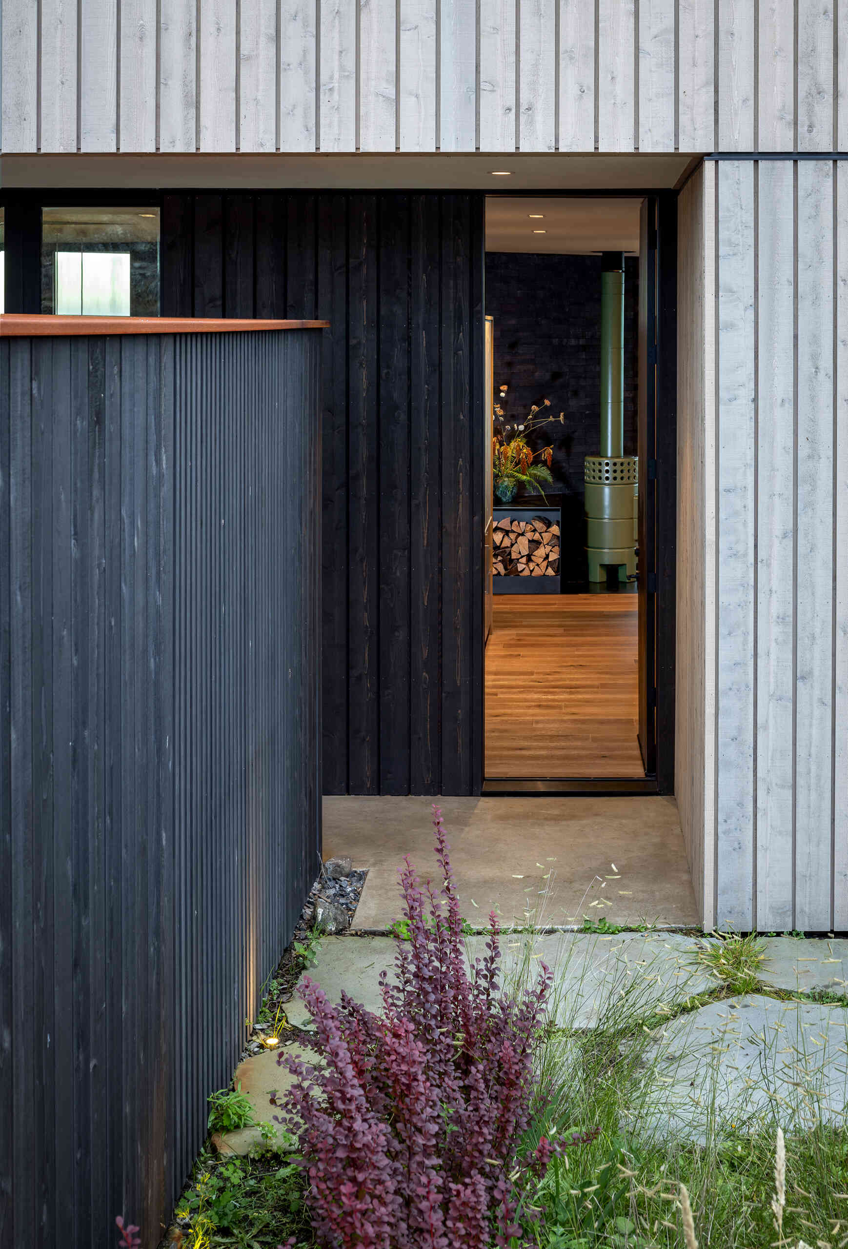 Cedar cladding and weathered finishes allow this home to blend into the rugged coastline.