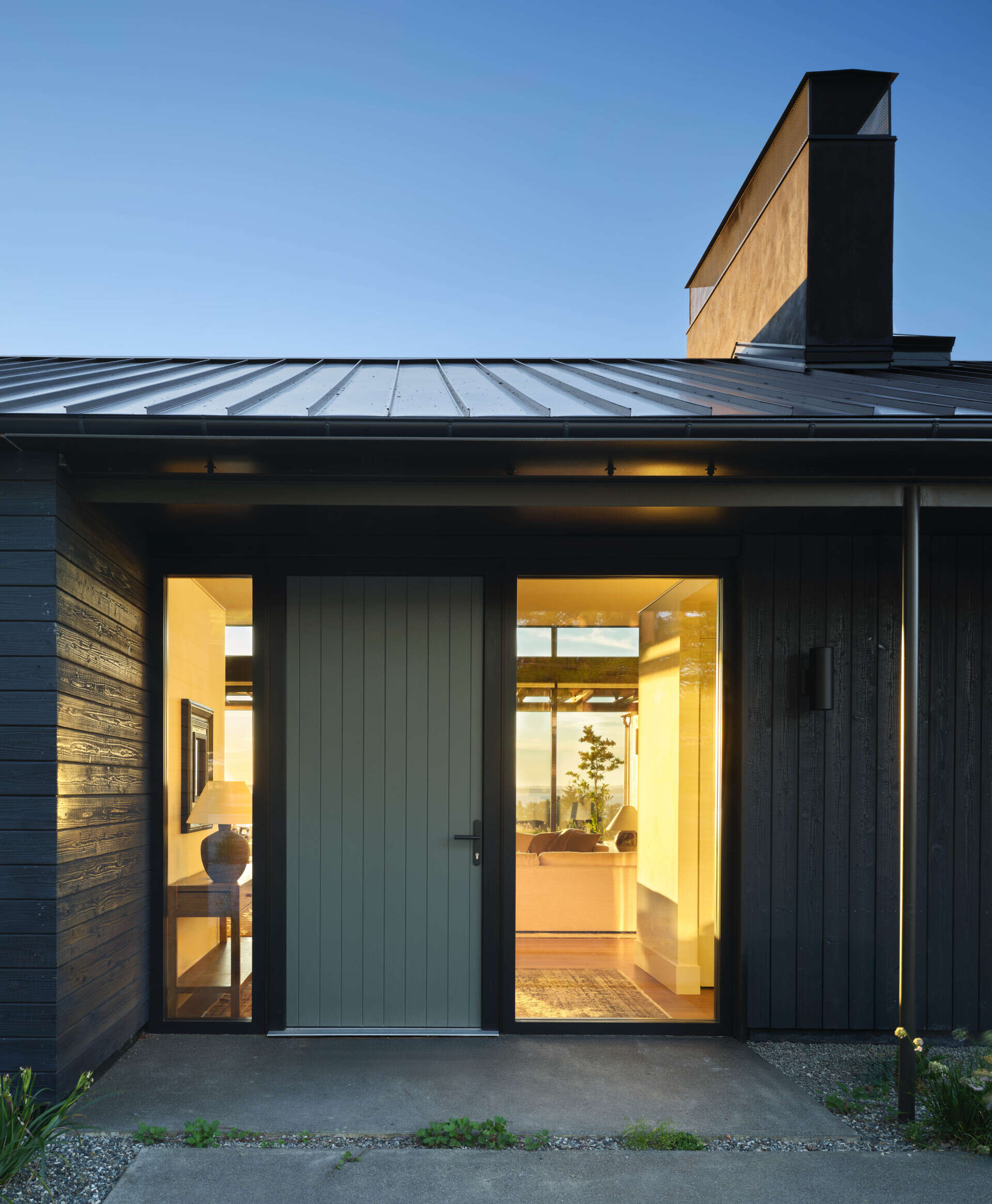 The entry is marked by a finely scaled steel canopy that creates a moment of pause before stepping inside. It’s subtle but precise, setting up the material language that continues throughout the house.