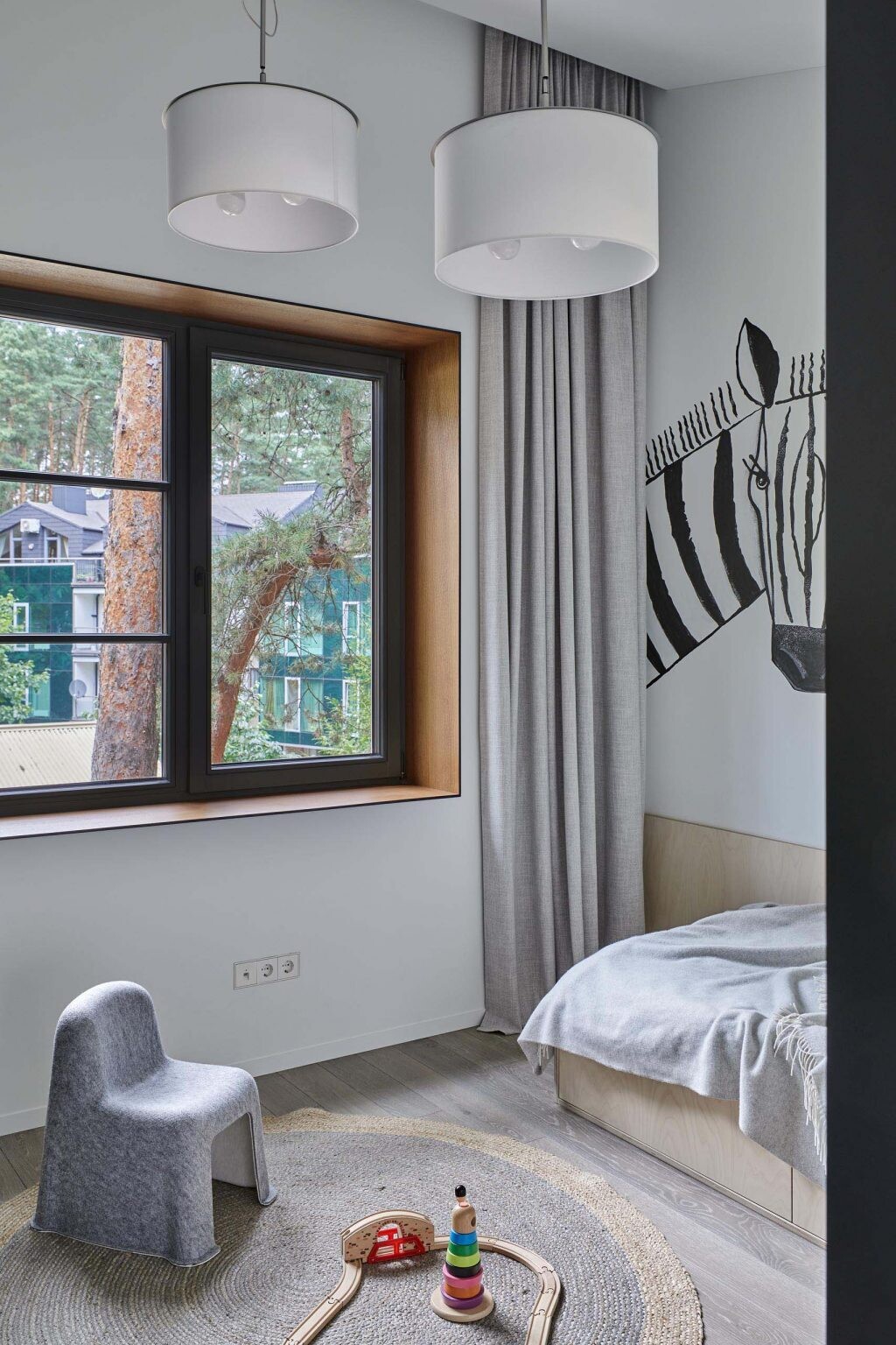 This kids bedroom includes a zebra artwork, a bold yellow shelf, and a green desk surrounded by storage, creating a bright and energetic environment.