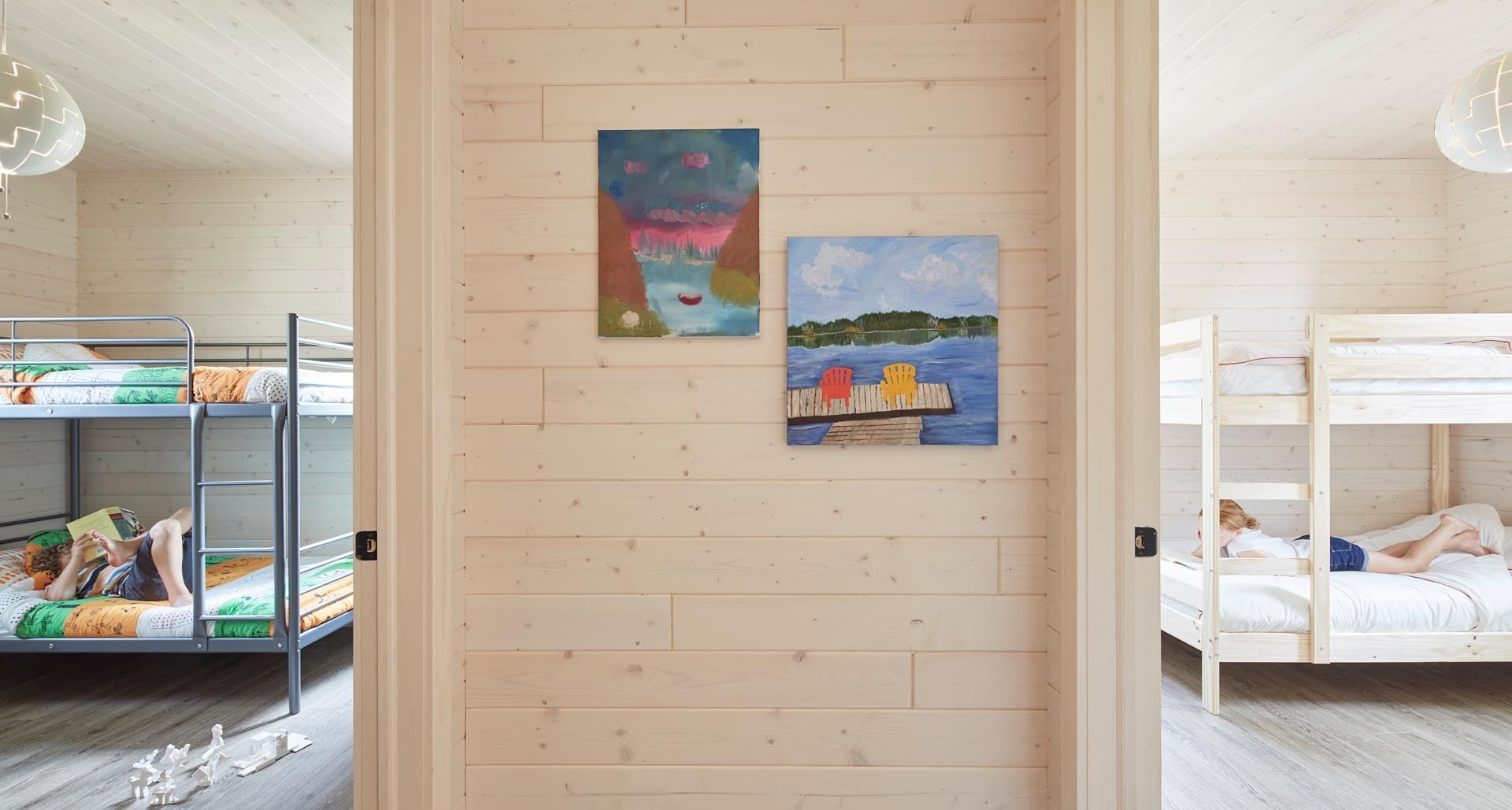 Warm timber bedrooms and space-saving bunk rooms make the lower level of this cottage ideal for hosting family and guests.