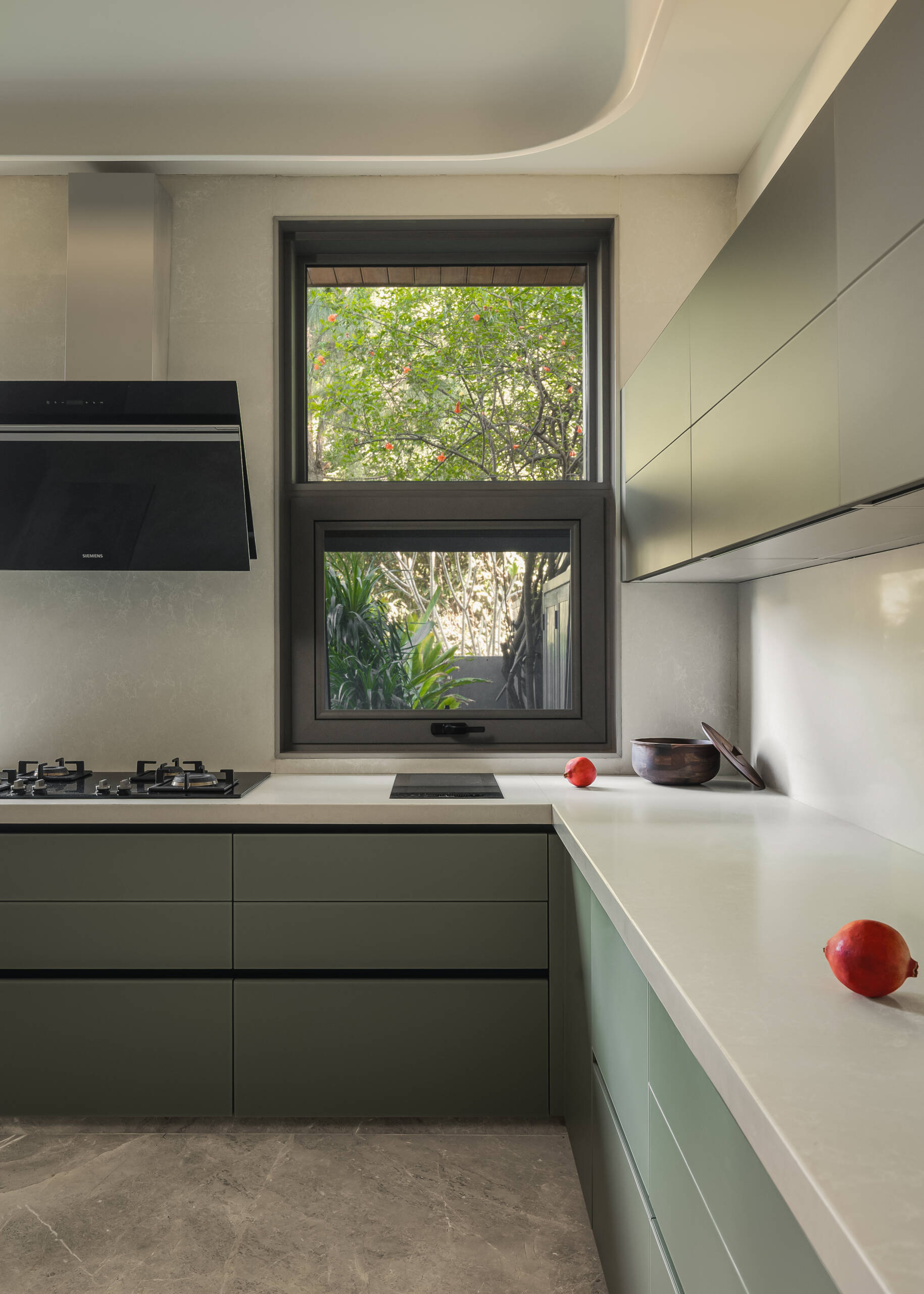 The kitchen with its clean surfaces and restrained color choices keep the space feeling open and easy to use.