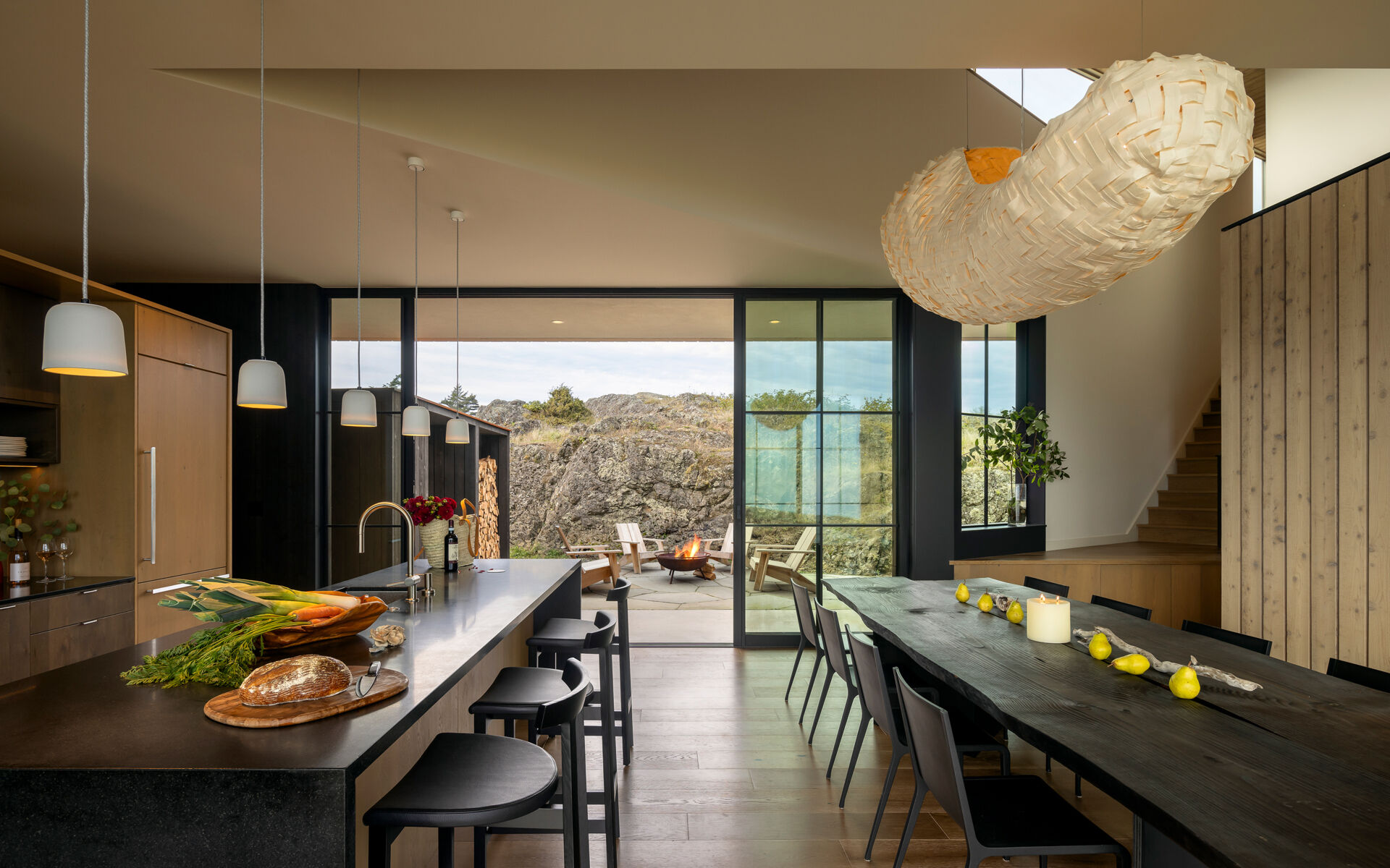An 11-foot dining table anchors this open-plan space designed for gathering and connection. The kitchen flows naturally from this space, keeping everything connected and open.