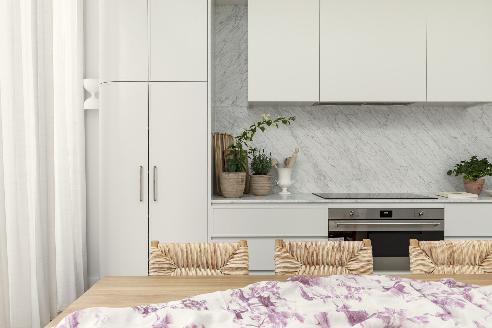 The kitchen follows a minimalist approach, with clean lines and a restrained palette. Natural stone countertops and backsplash, cabinets with curved designs, and timber from the island introduce texture and depth without relying on bold color.