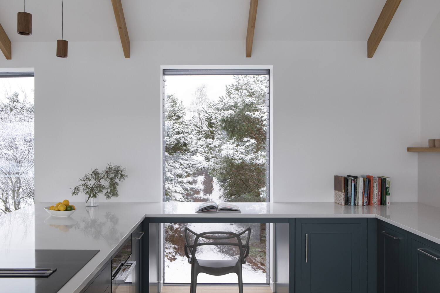 Colorful cabinetry and a waterfall-edge countertop bring contrast and practicality to the kitchen.