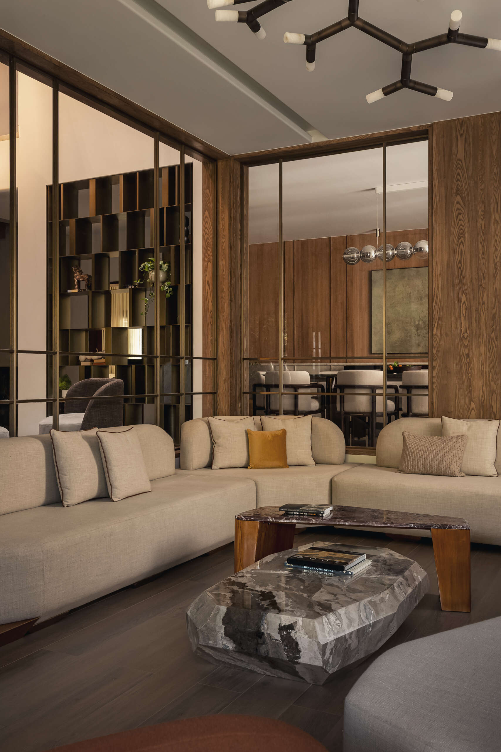 The living room continues the idea of softness and balance. Muted tones form the base, allowing the materials to stand out without overwhelming the space.