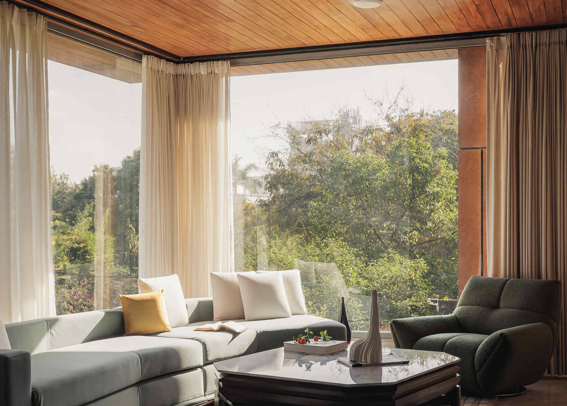 A modern living room with full-height windows.