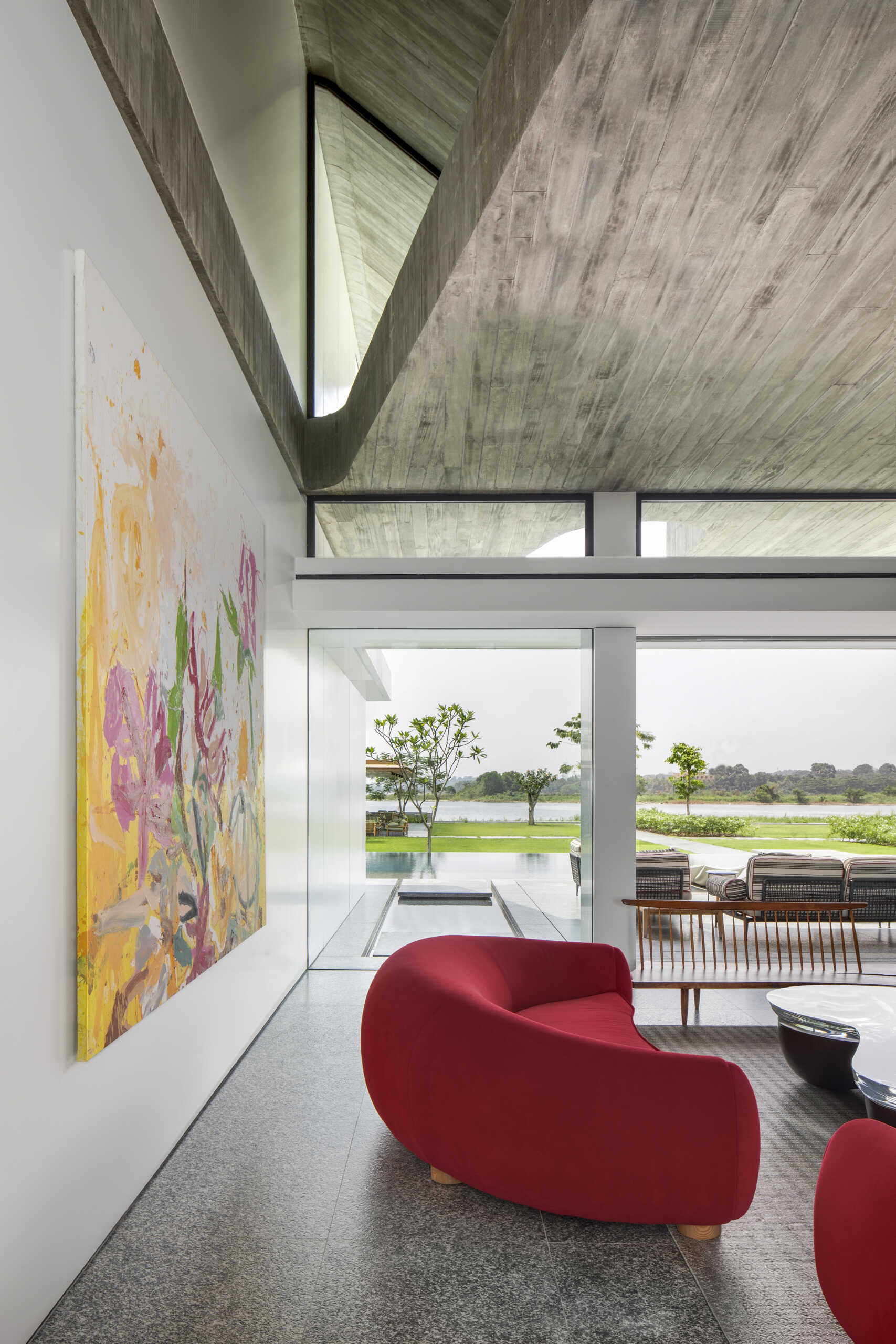 Colourful furniture and sculptural pieces in the living area brings energy into a neutral architectural shell.