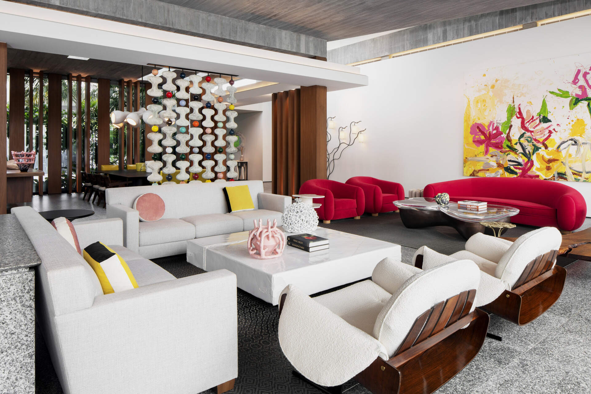 Colourful furniture and sculptural pieces in the living area brings energy into a neutral architectural shell.