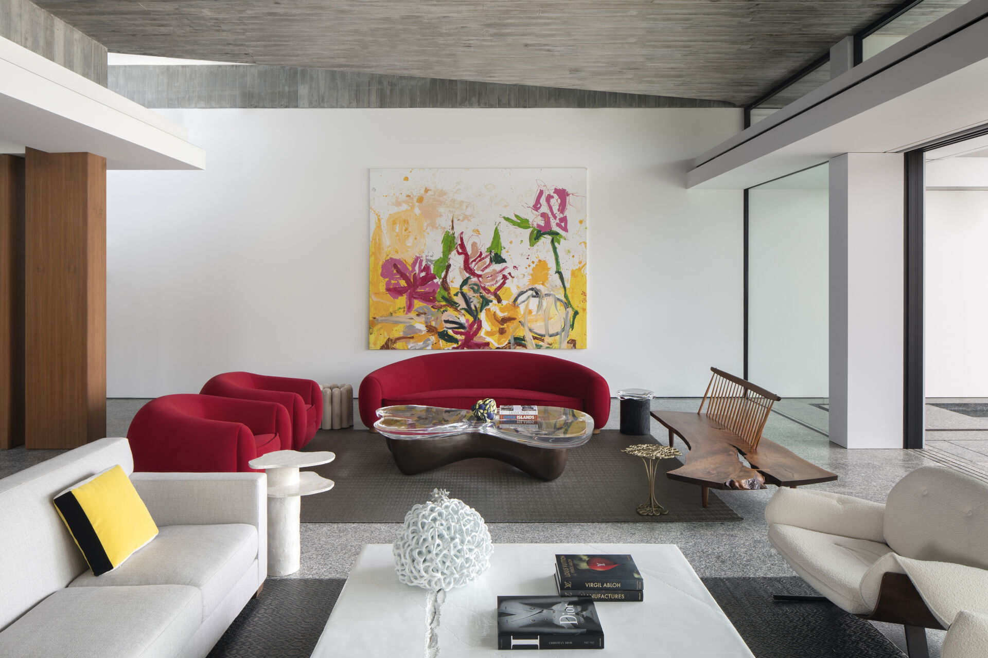Colourful furniture and sculptural pieces in the living area brings energy into a neutral architectural shell.