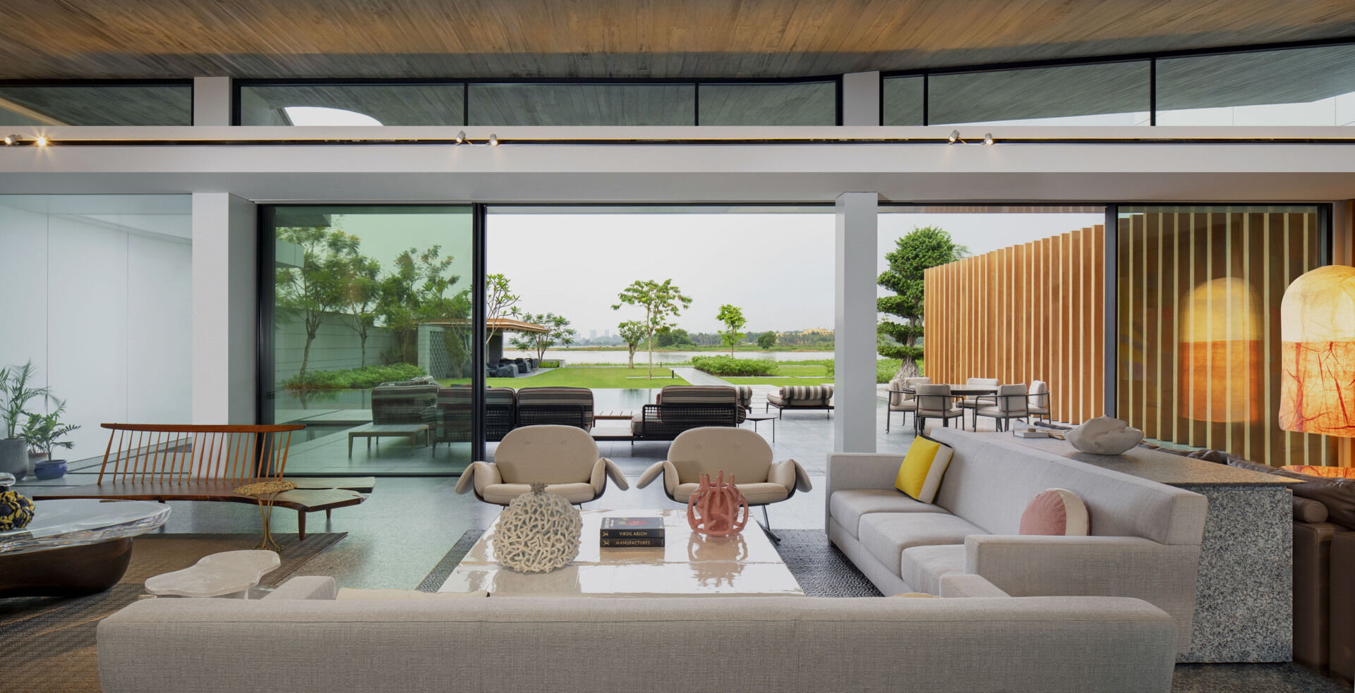 Colourful furniture and sculptural pieces in the living area brings energy into a neutral architectural shell.