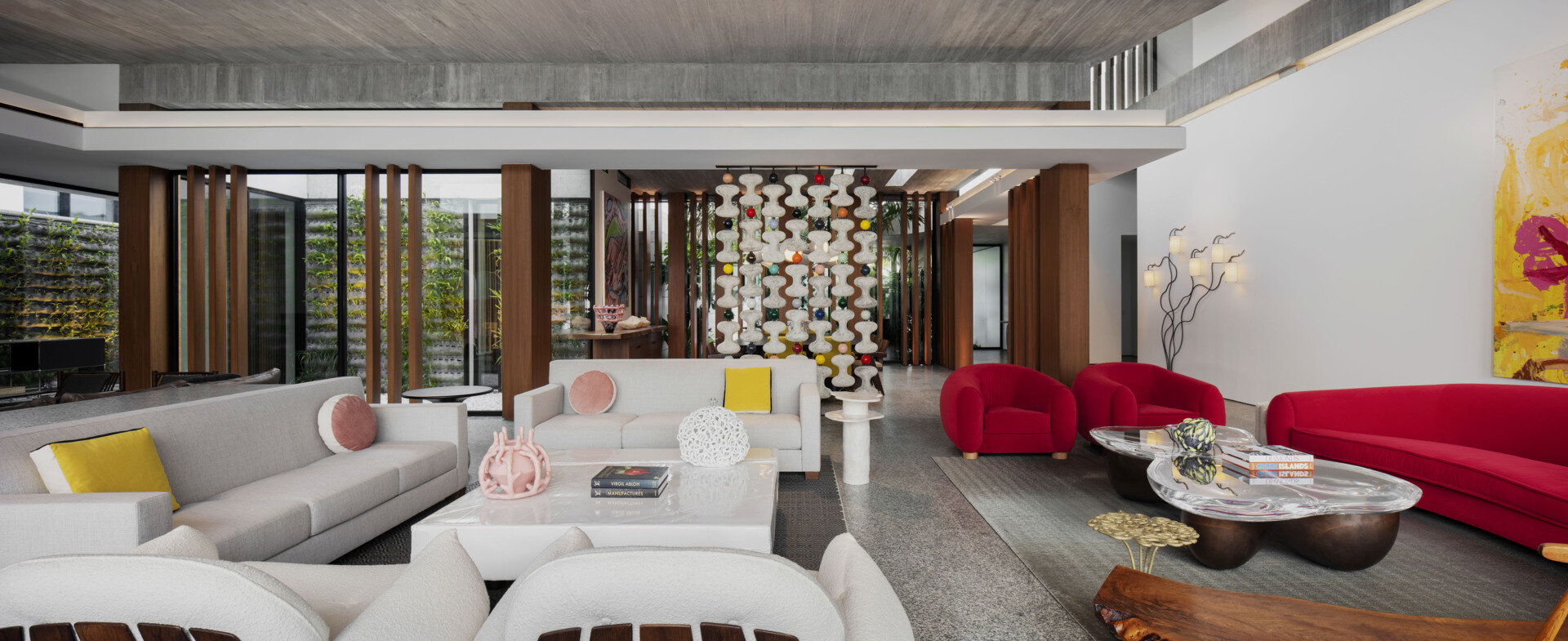 Colourful furniture and sculptural pieces in the living area brings energy into a neutral architectural shell.