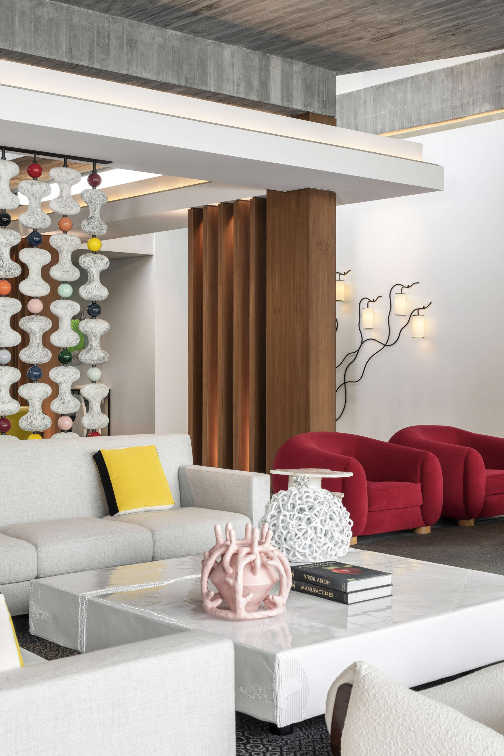 Colourful furniture and sculptural pieces in the living area brings energy into a neutral architectural shell.