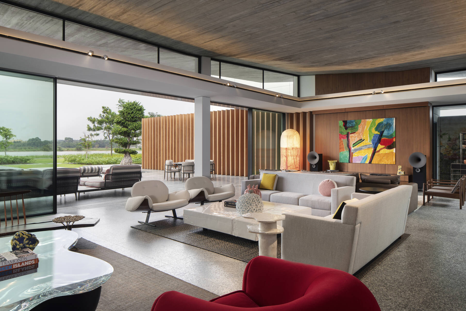 Colourful furniture and sculptural pieces in the living area brings energy into a neutral architectural shell.