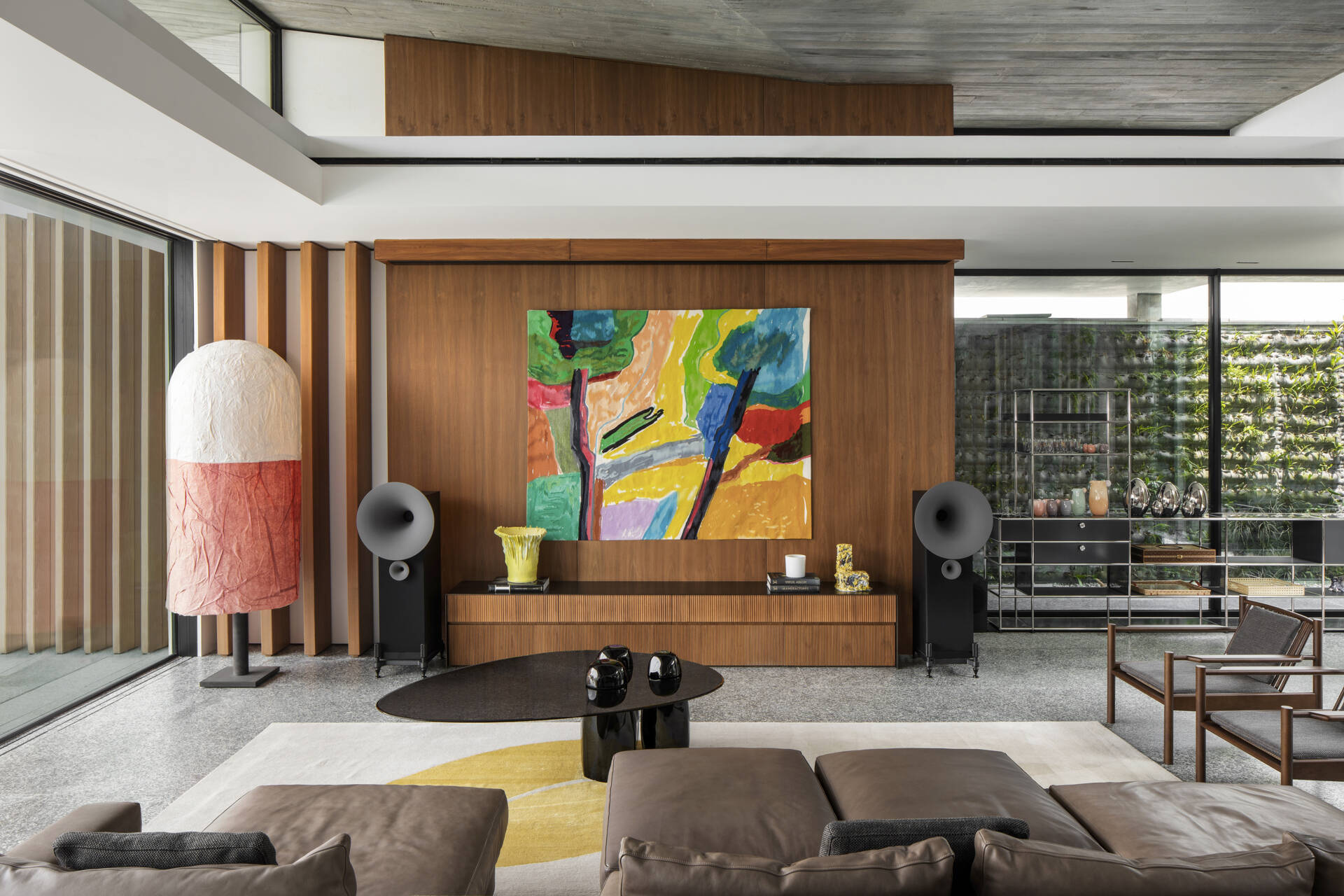 Colourful furniture and sculptural pieces in the living area brings energy into a neutral architectural shell.
