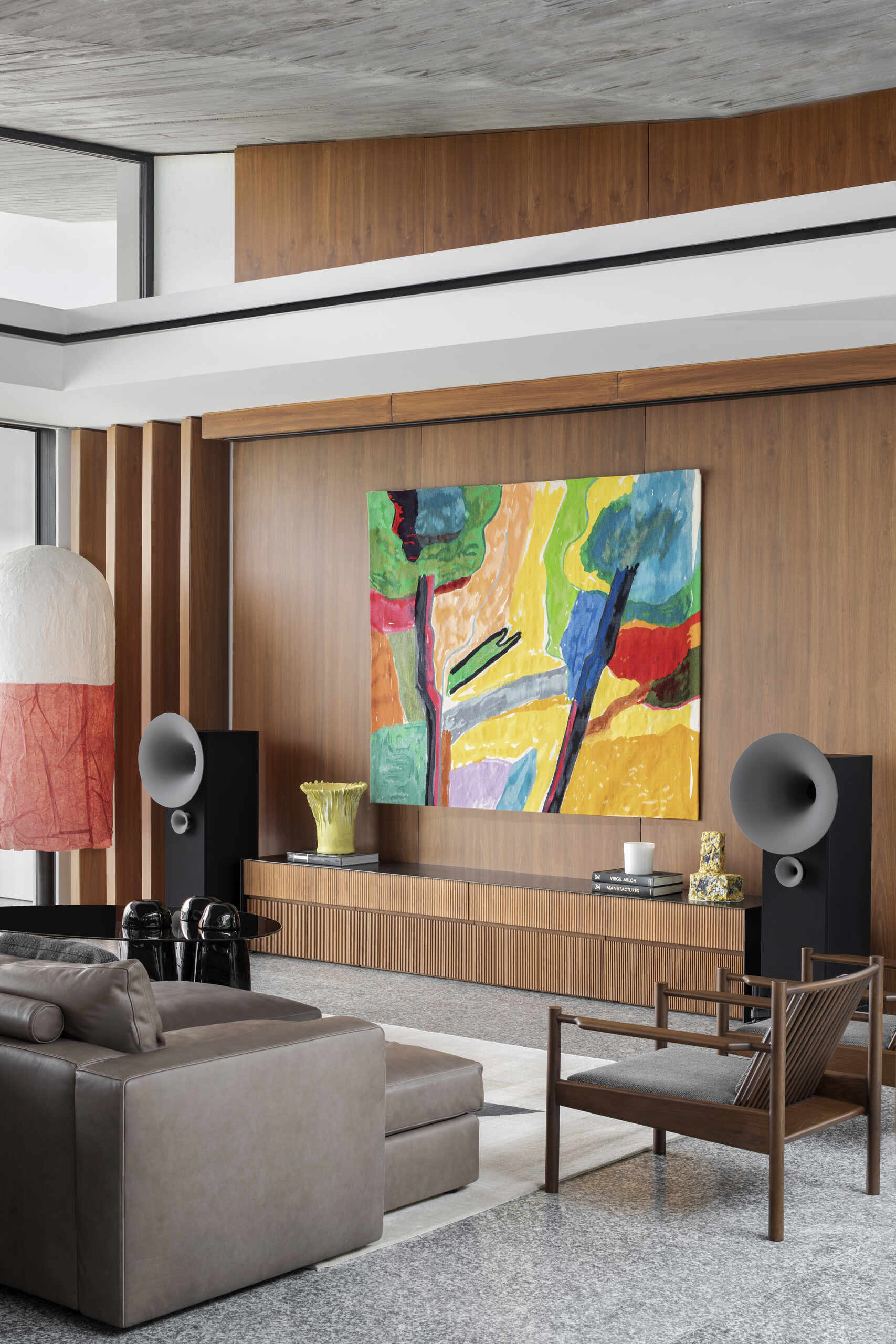 Colourful furniture and sculptural pieces in the living area brings energy into a neutral architectural shell.