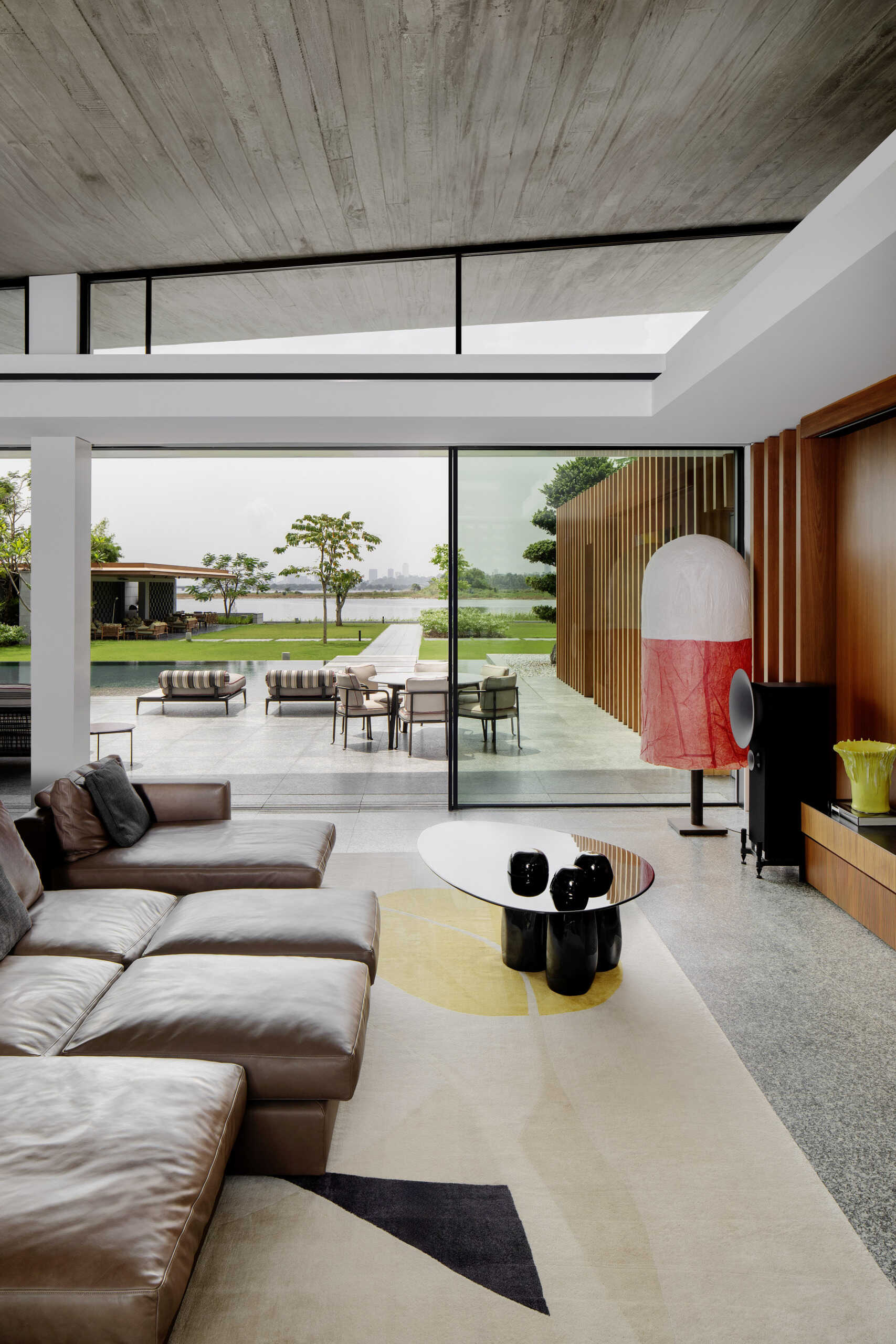 Colourful furniture and sculptural pieces in the living area brings energy into a neutral architectural shell.