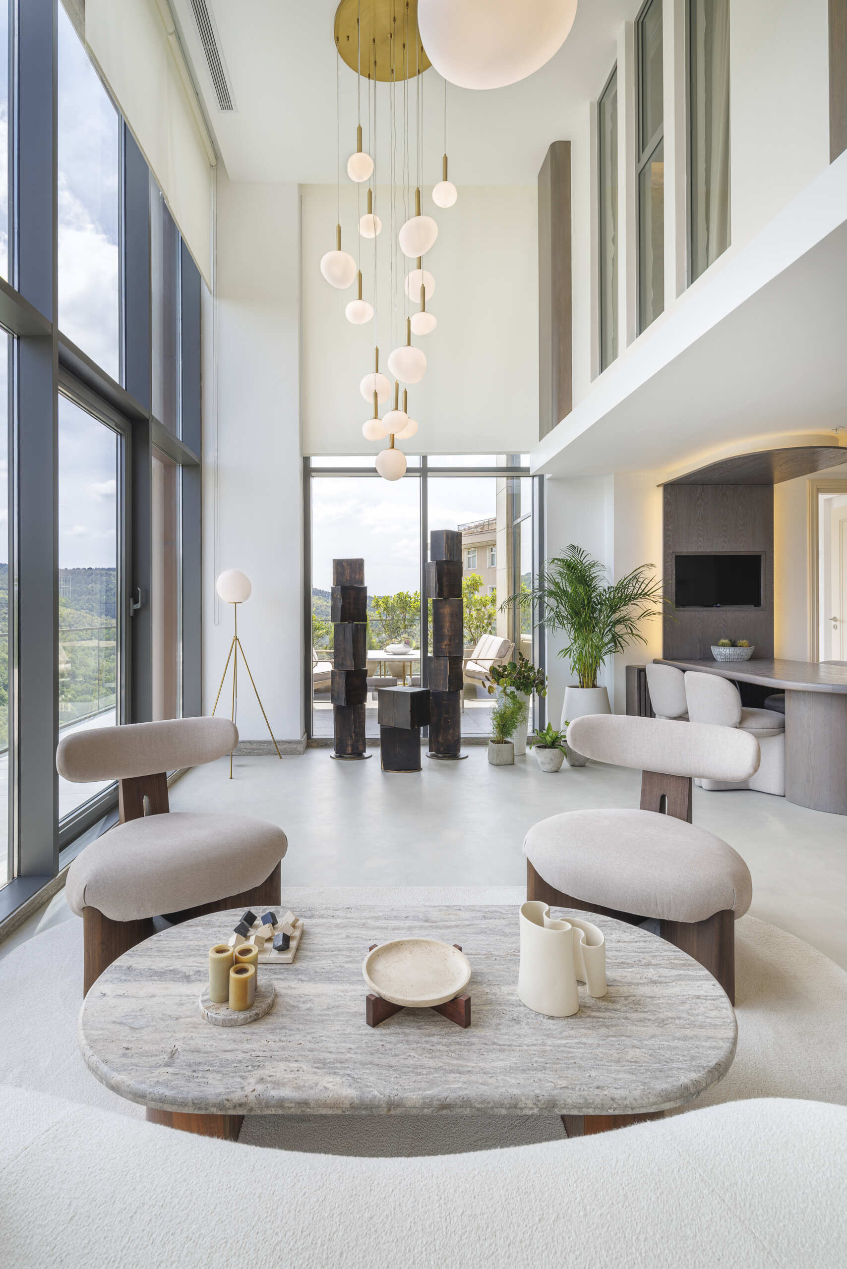 Sculptural wood figures, a soaring curved wall, and a floor-to-ceiling library shape a space that explores growth through design.