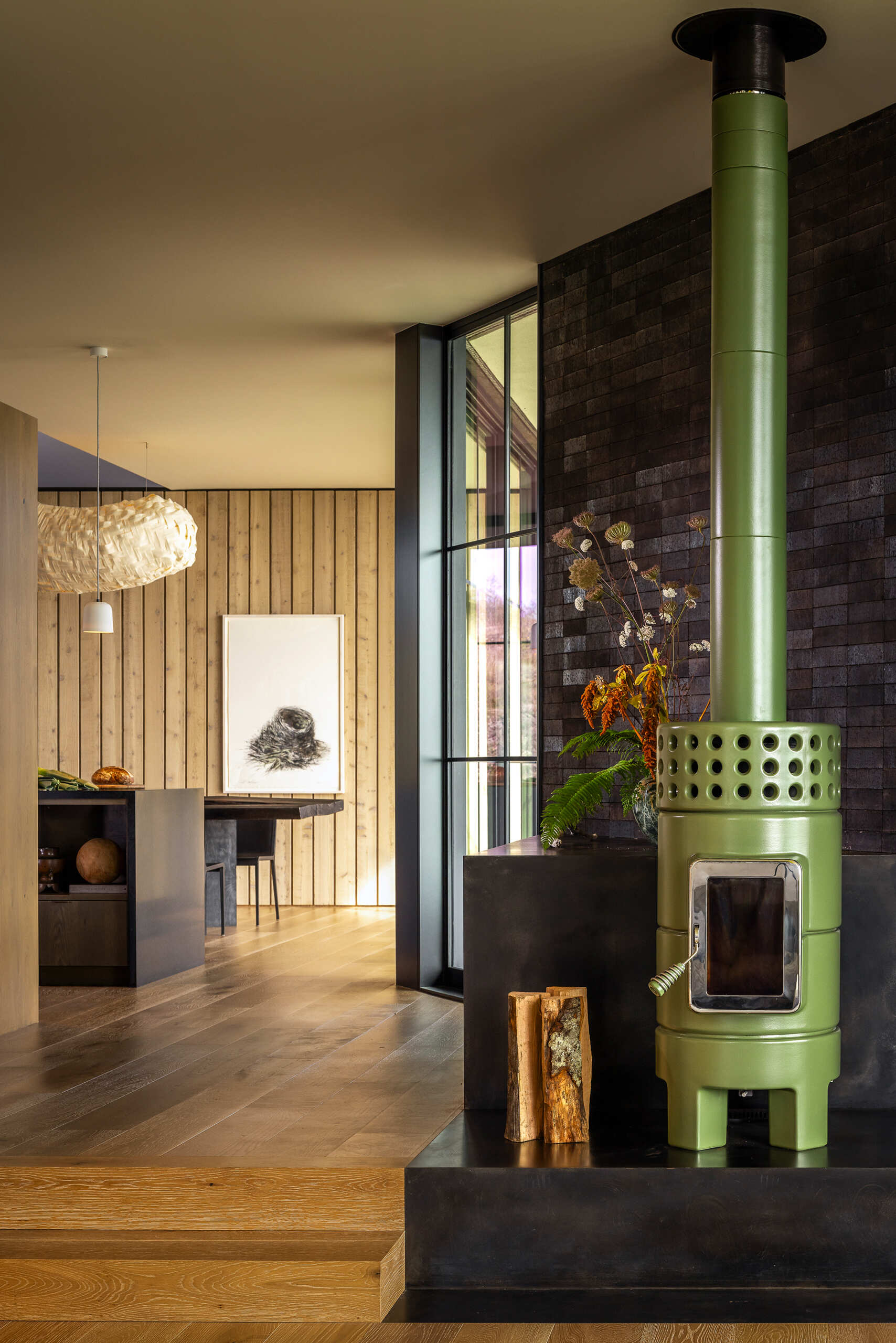 Neutral interiors and large glass doors frame uninterrupted views of water and rock.