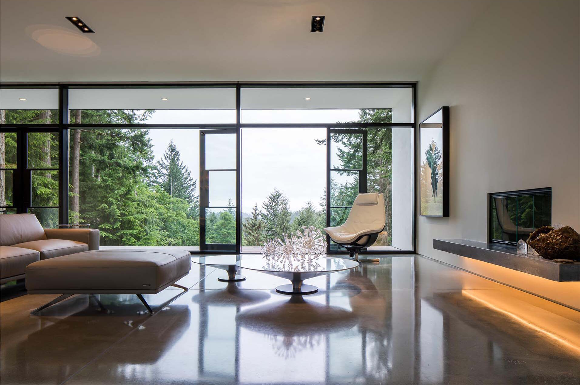 White surfaces, marble, and concrete create a gallery-like interior designed to highlight art and objects.