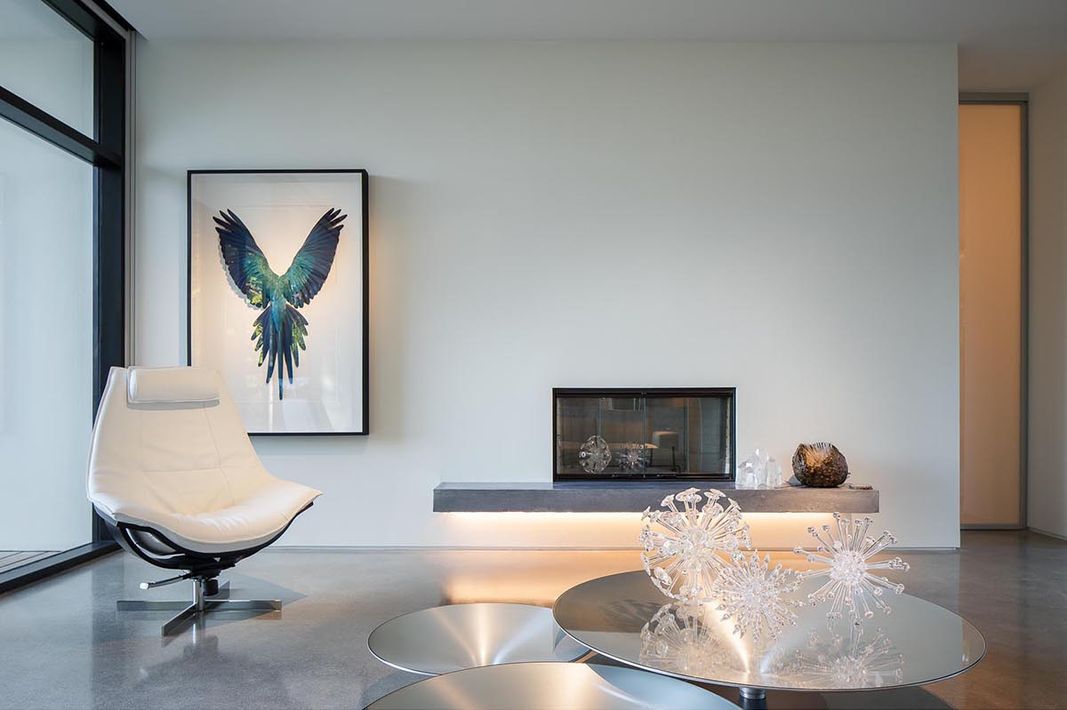 A floating fireplace and custom display cabinetry bring gallery-style lighting and focus into the living space.