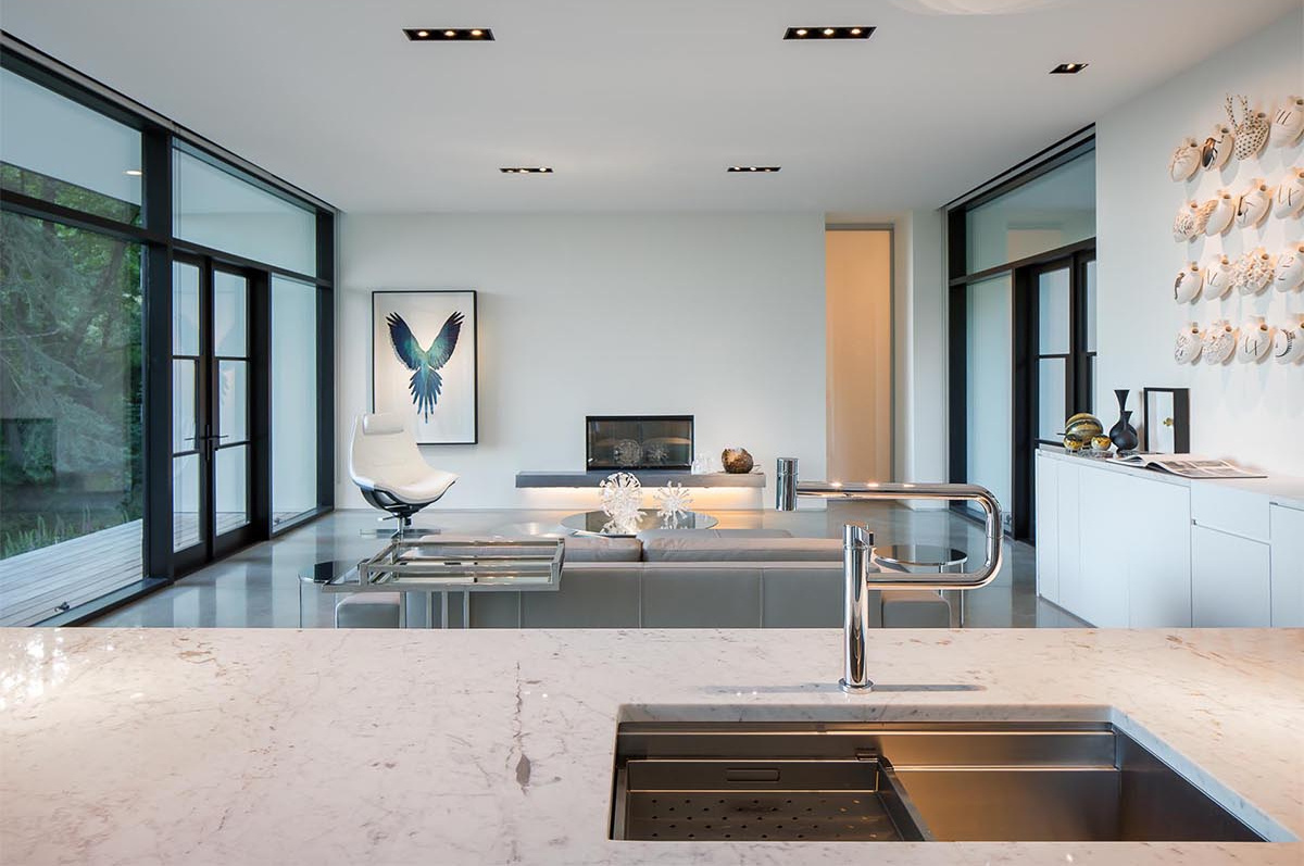 A floating fireplace and custom display cabinetry bring gallery-style lighting and focus into the living space.