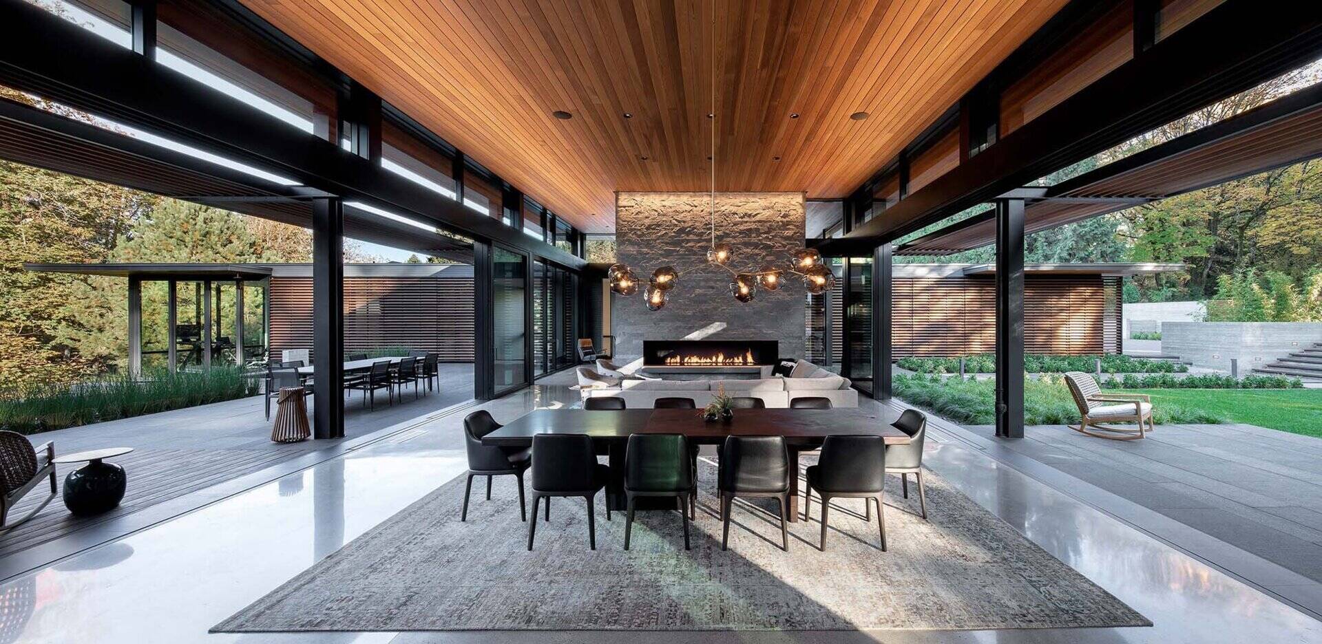 An open plan living space with retractable glass walls that fully connects to the outdoors. A seamless indoor outdoor layout perfect for entertaining.
