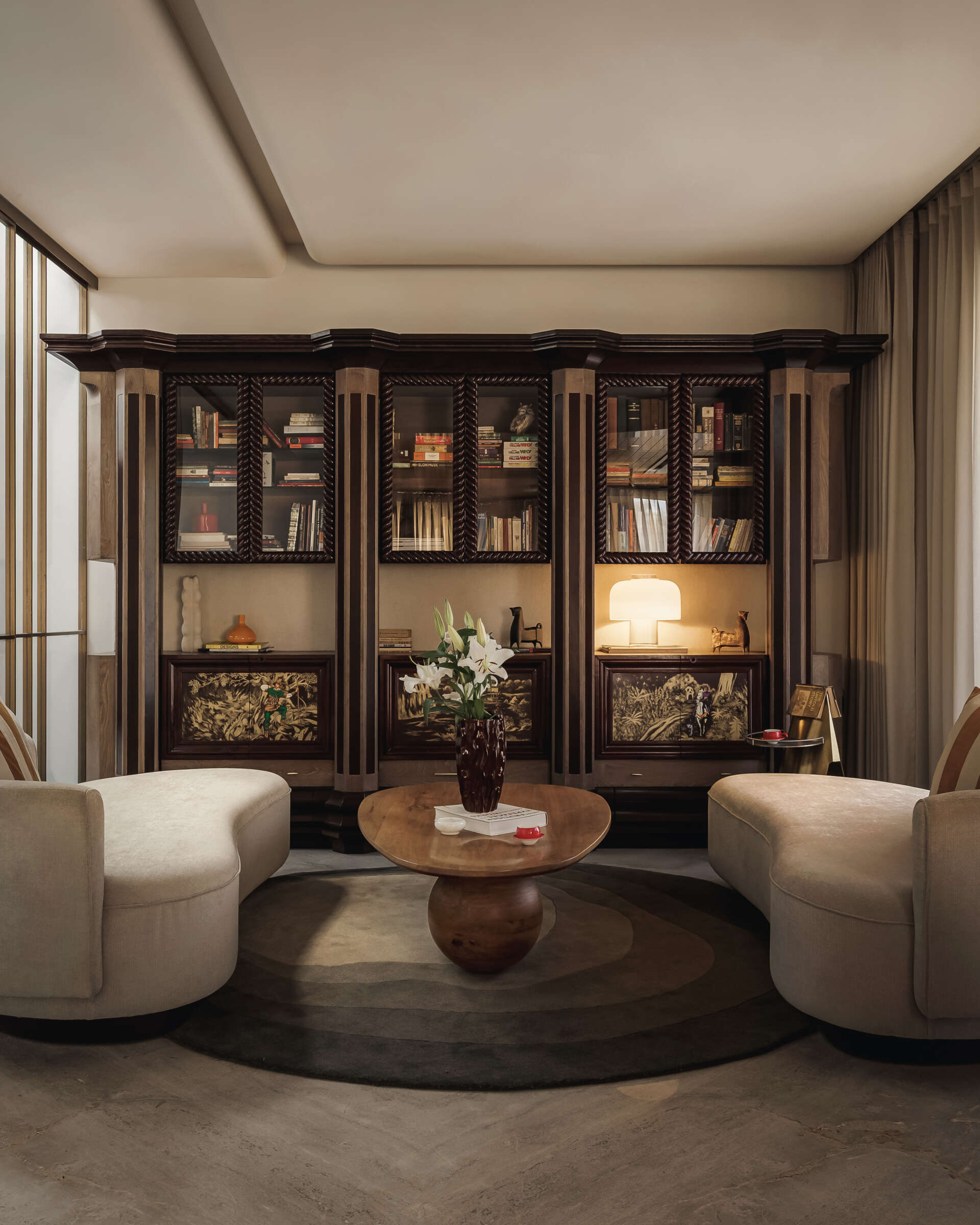 The library, located below the den, feels like a place that will evolve over time, especially as objects, books, and collected pieces fill the shelves.