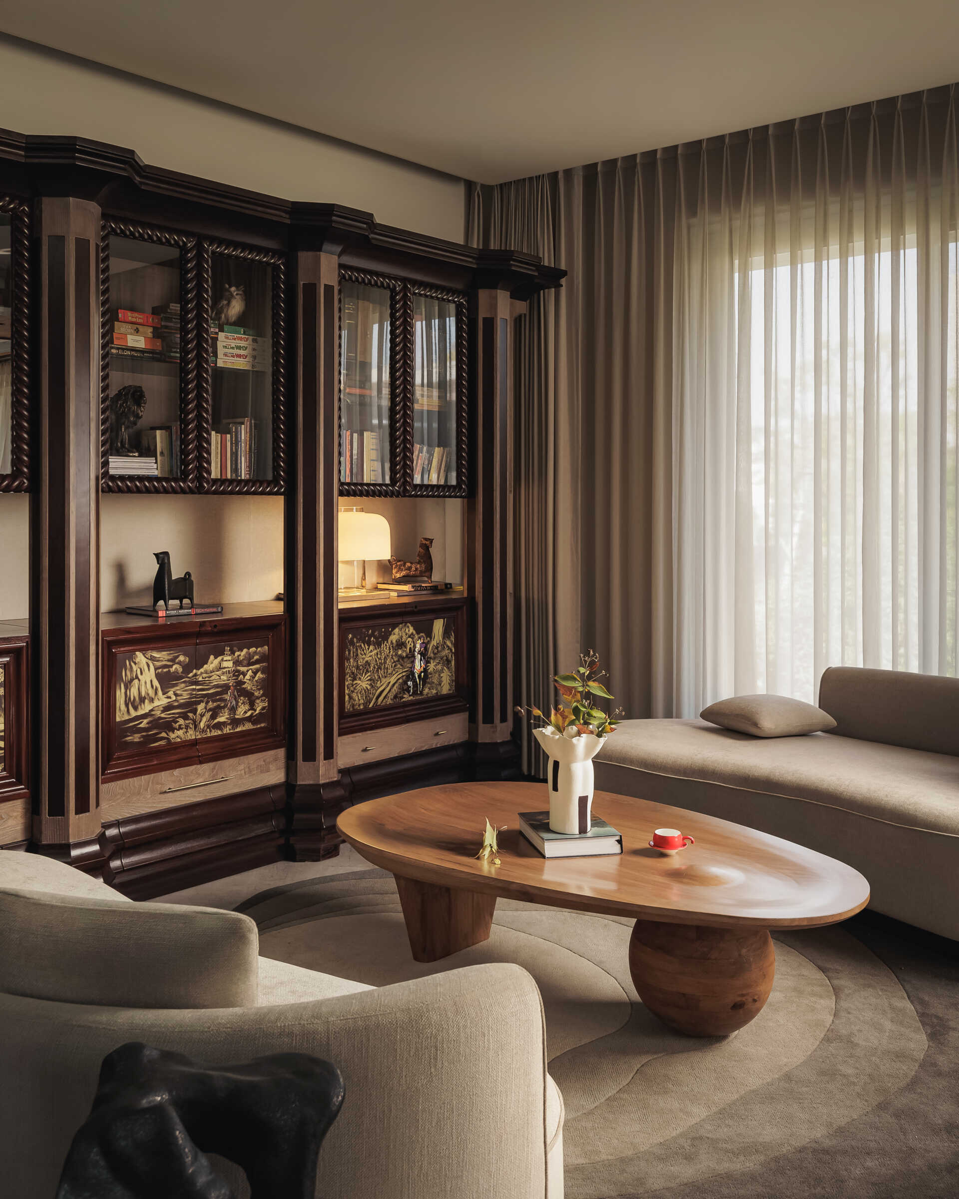 The library, located below the den, feels like a place that will evolve over time, especially as objects, books, and collected pieces fill the shelves.