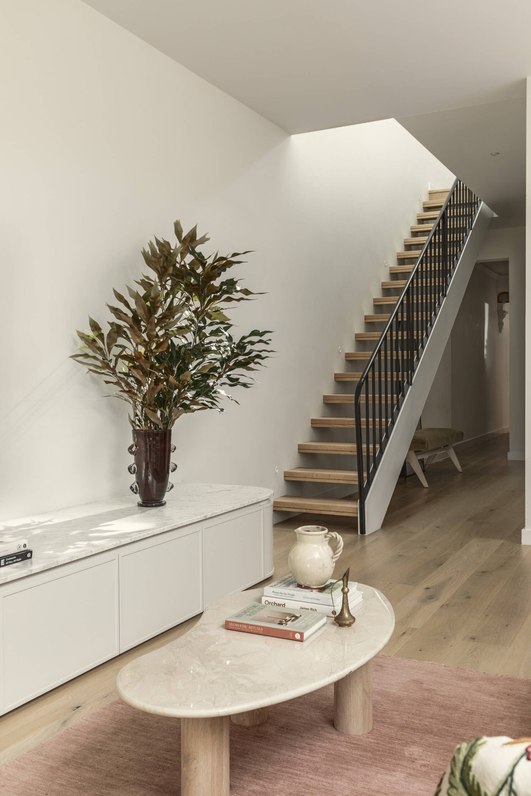 The staircase links the two levels, continuing the home’s clean and simple design language. It acts as both a functional element and a visual connector between floors.