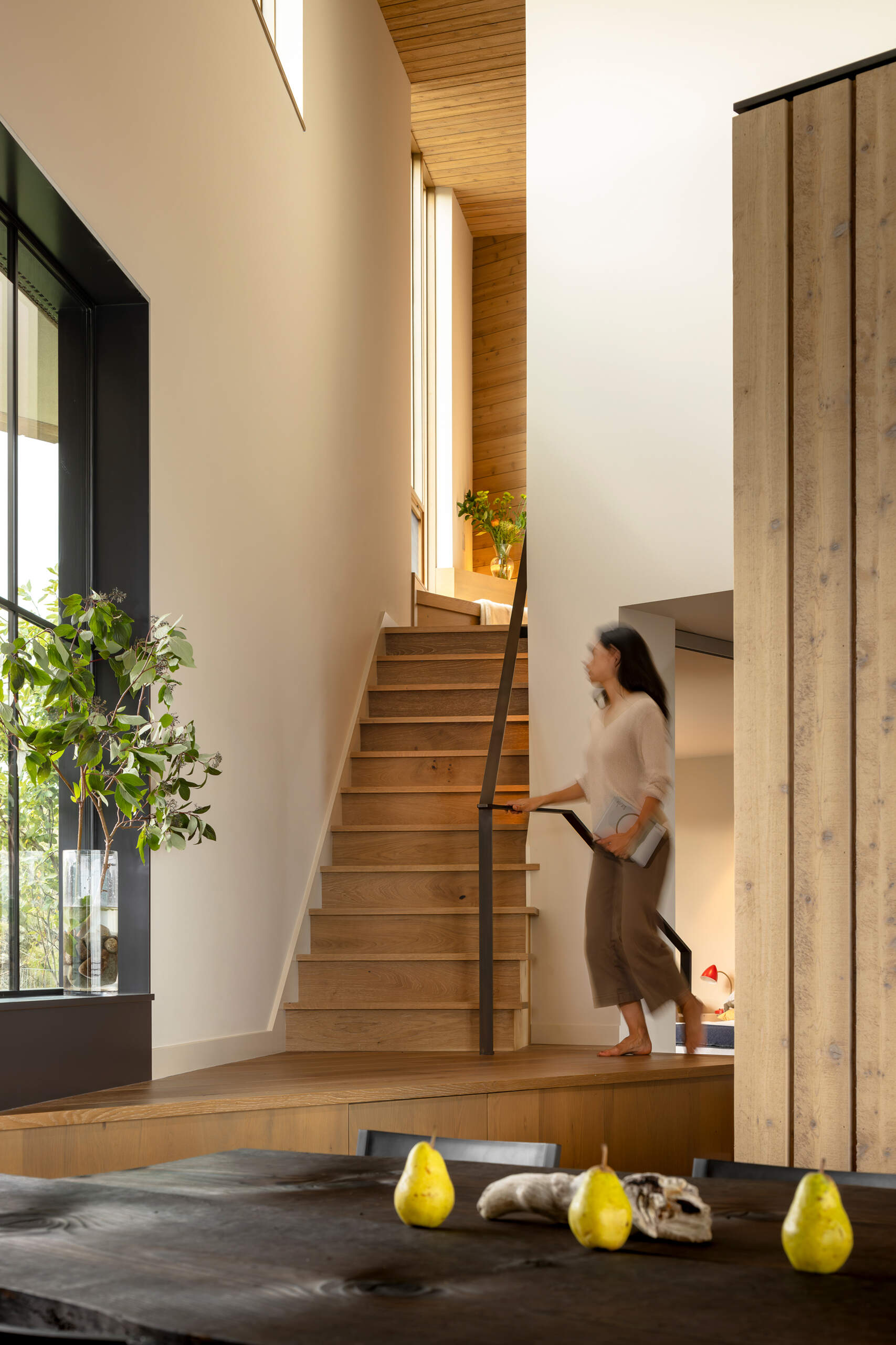 The stairs connect the grounded, solid feel of the lower level with the lighter, more elevated spaces above. Positioned efficiently within the plan, they maintain the clean flow of the interior without interrupting sightlines.