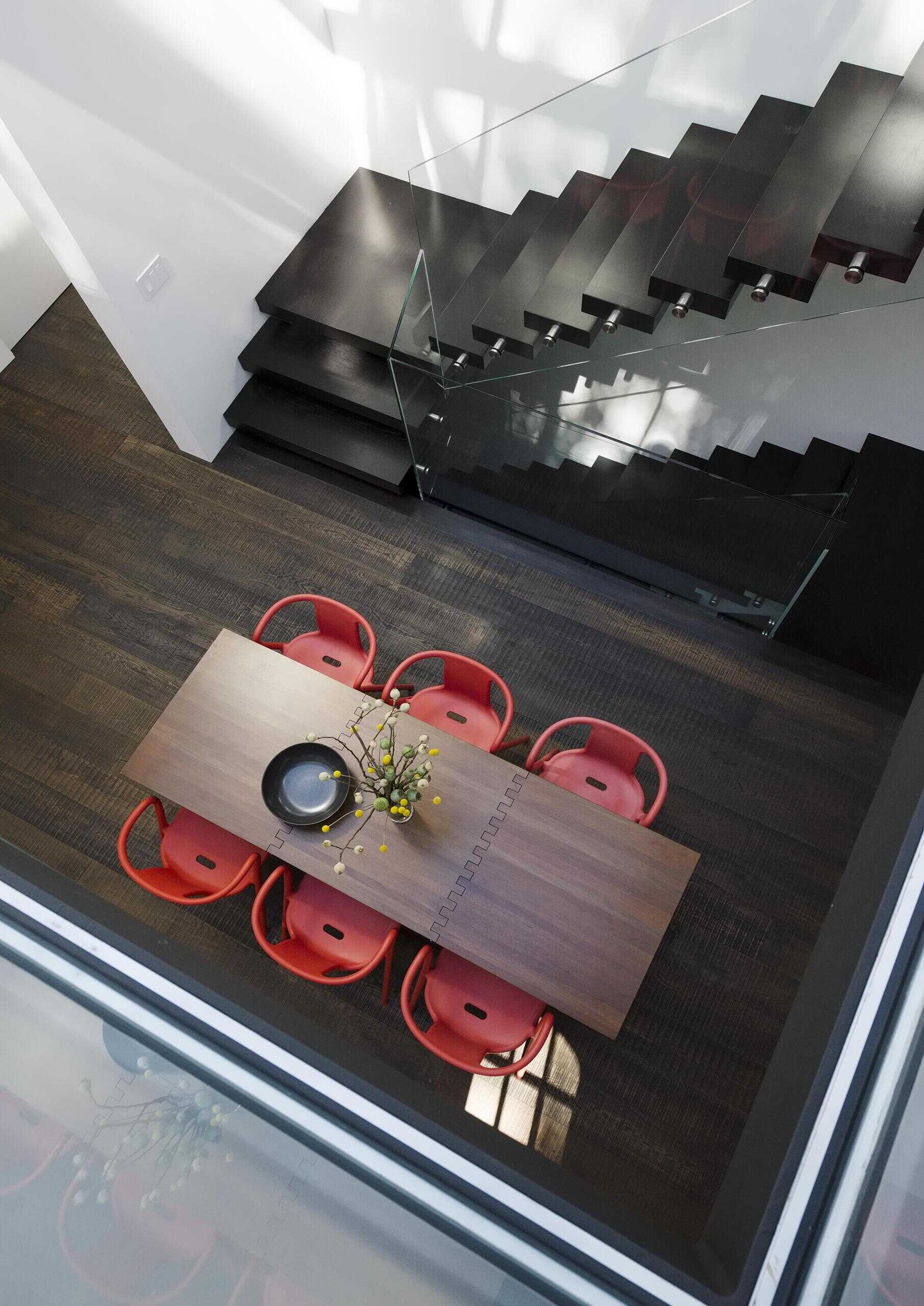 A modern interior bridge with acrylic flooring overlooking a double-height atrium, adding lightness and connection.