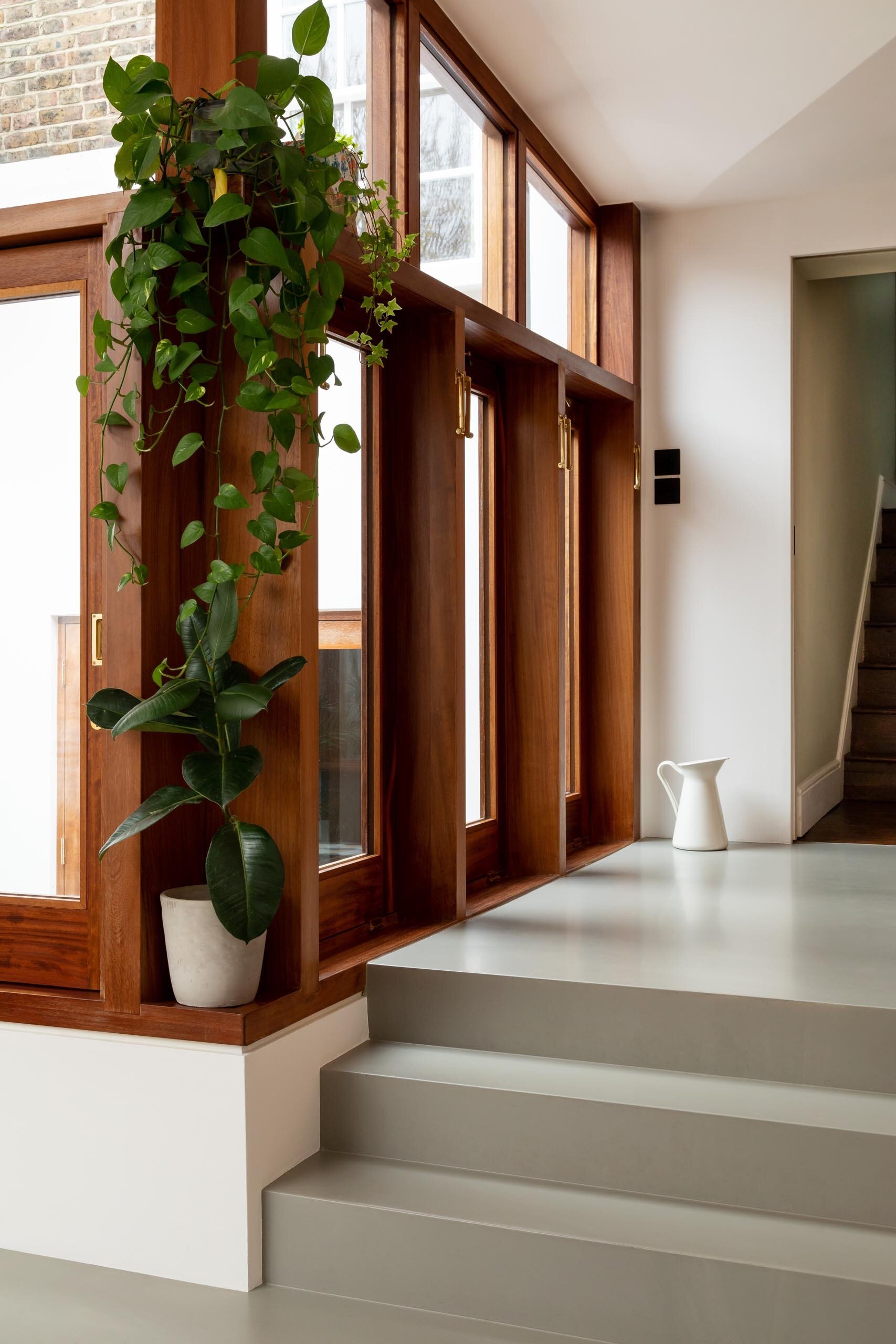 Thick wood window frames add warmth and texture to this clean, modern interior.