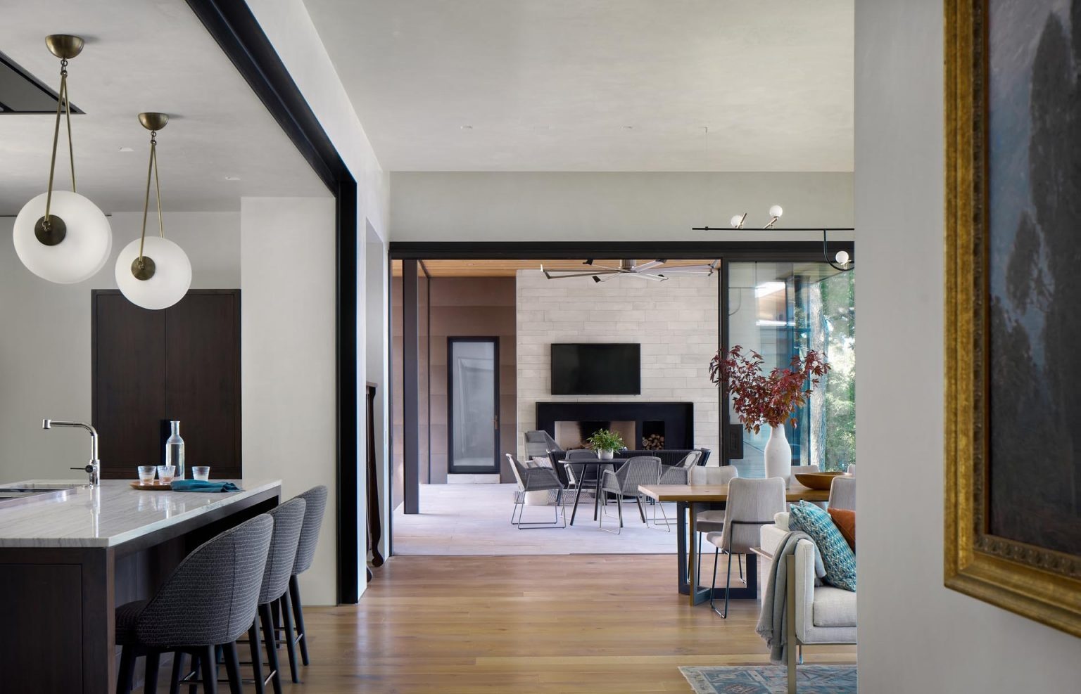Floor-to-ceiling windows open the living and dining spaces to the outdoors, filling the home with natural light and uninterrupted lake views.