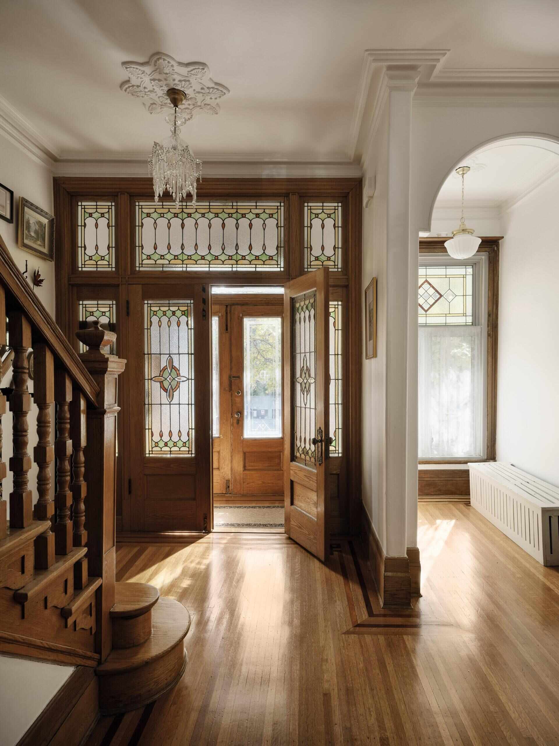 Original features such as stained glass, moldings, and woodwork were restored and remain central to the home’s identity.