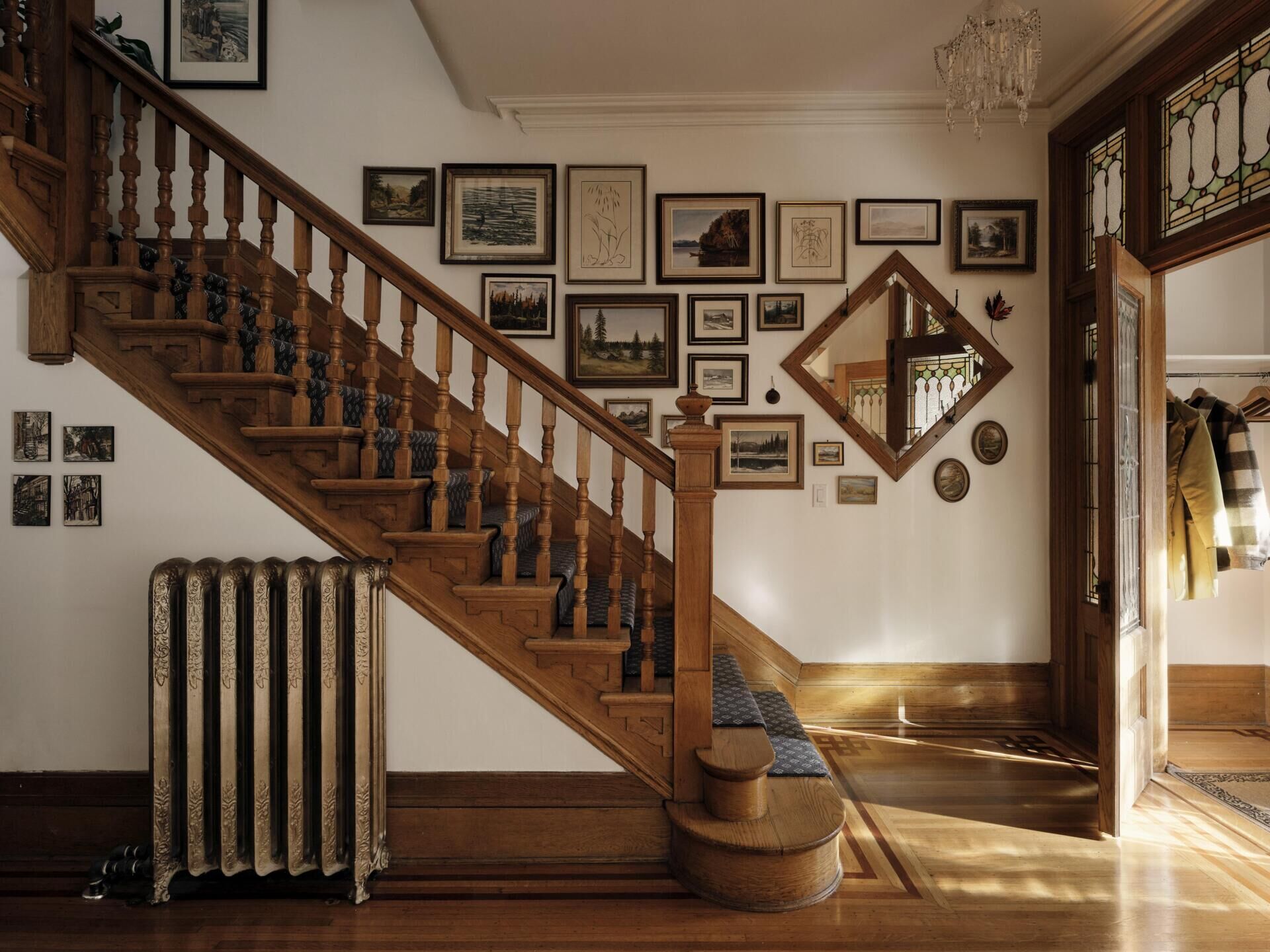 Original features such as stained glass, moldings, and woodwork were restored and remain central to the home’s identity.