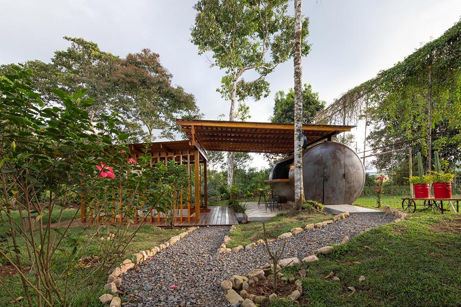 This outdoor pavilion combines a conversation pit and a converted tank to create a flexible space for gatherings and downtime.