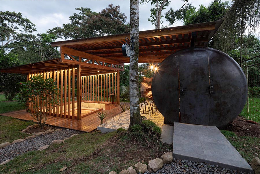 This outdoor pavilion combines a conversation pit and a converted tank to create a flexible space for gatherings and downtime.