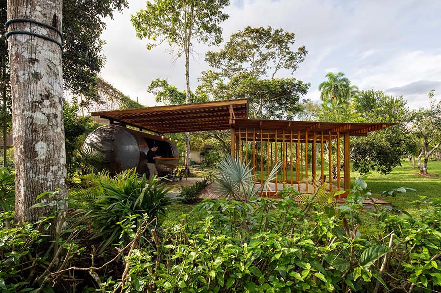 This outdoor pavilion combines a conversation pit and a converted tank to create a flexible space for gatherings and downtime.