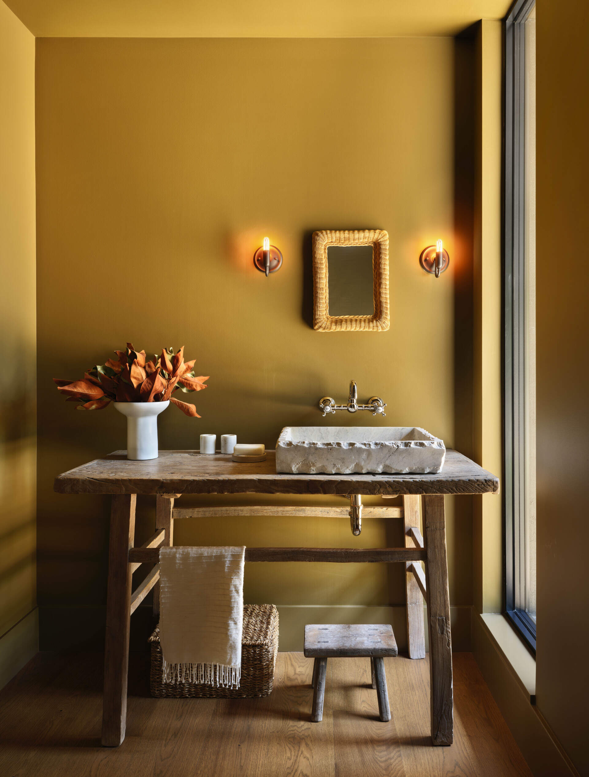 Mustard walls add a bold pop of color in this compact powder room.