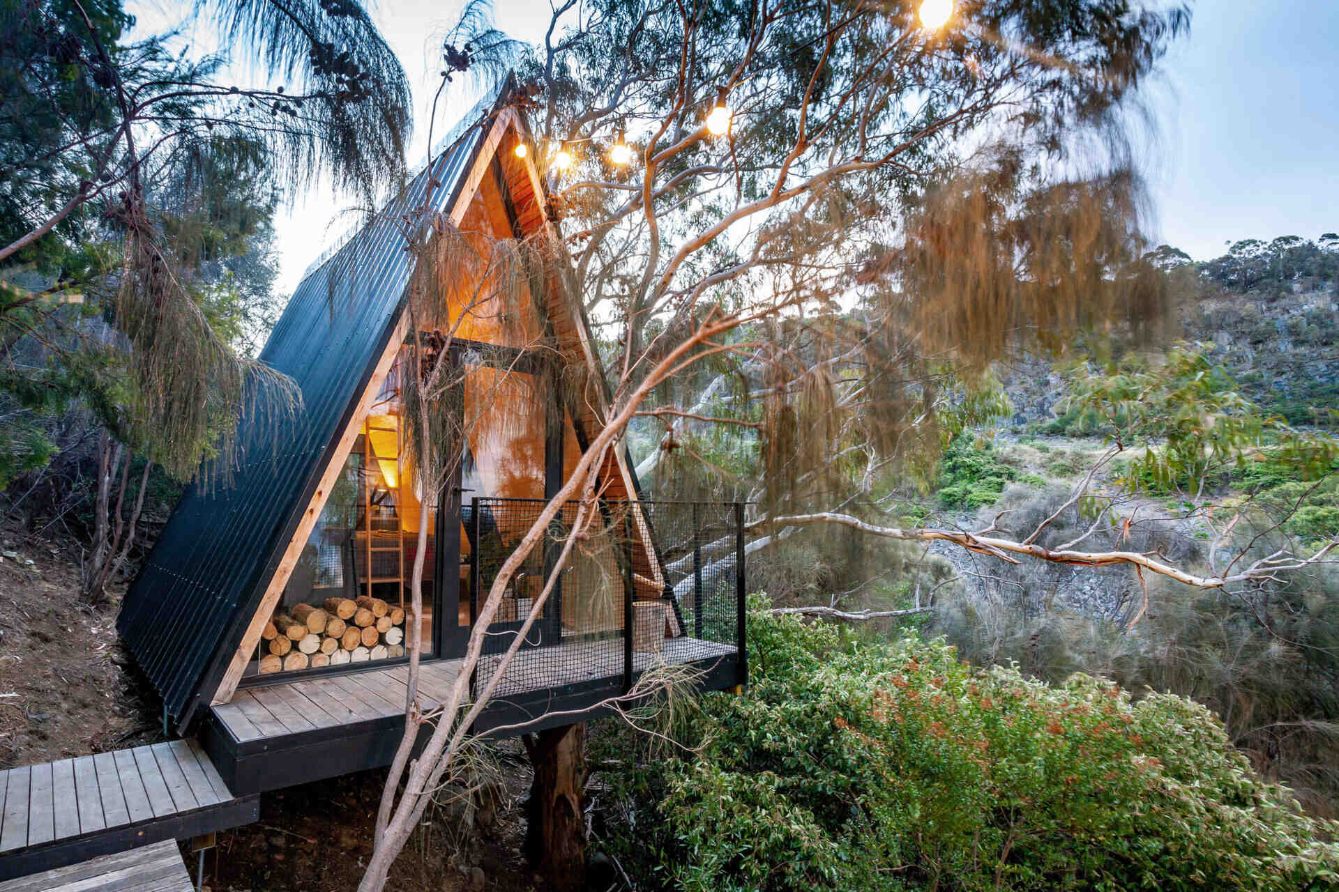 A small A-frame cabin set in Australian bushland, designed as a playful hideout for kids with space to explore and unwind.