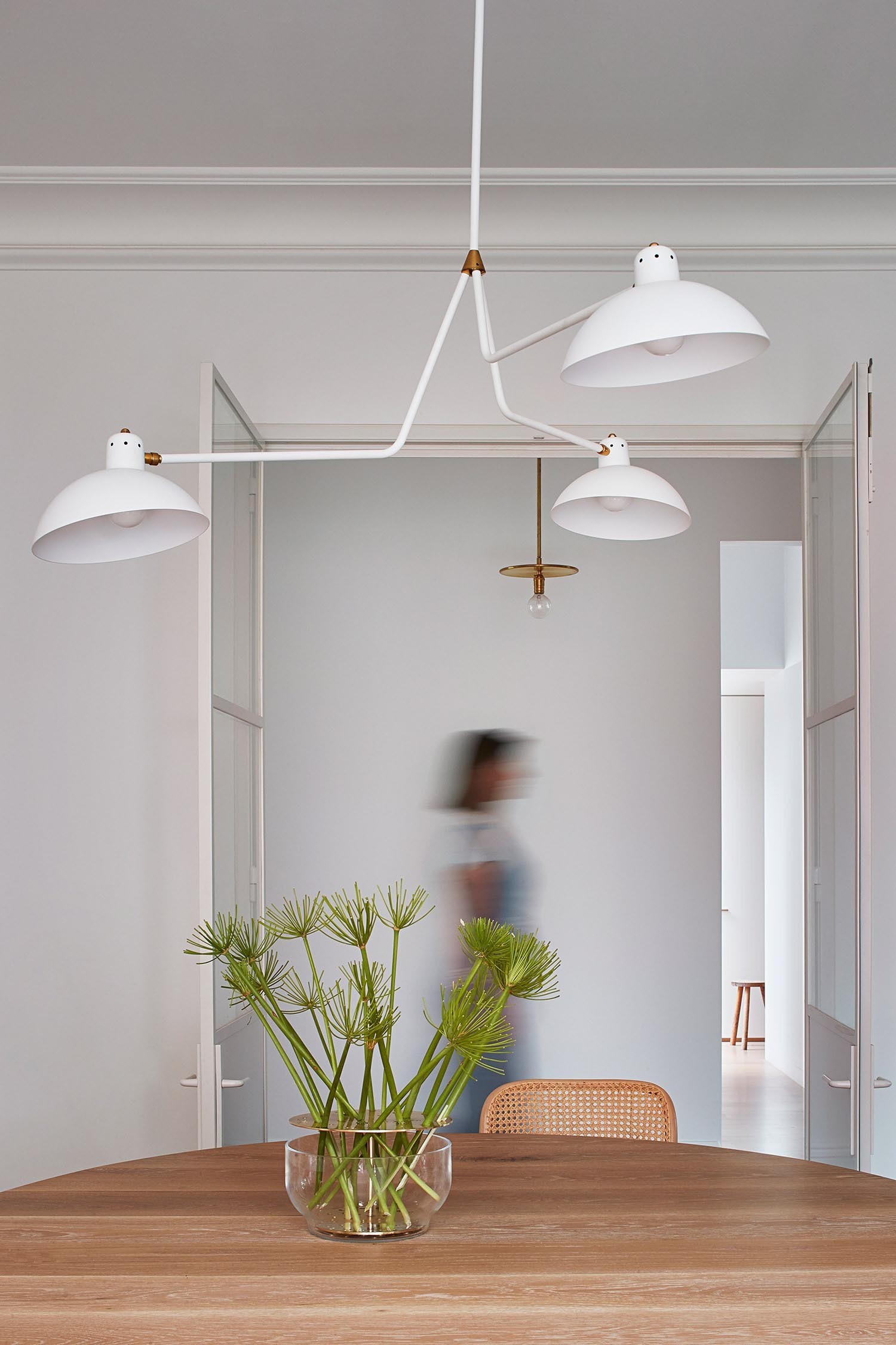 A cozy dining nook with a built-in bench and stained glass window that reflects the home’s original design features.