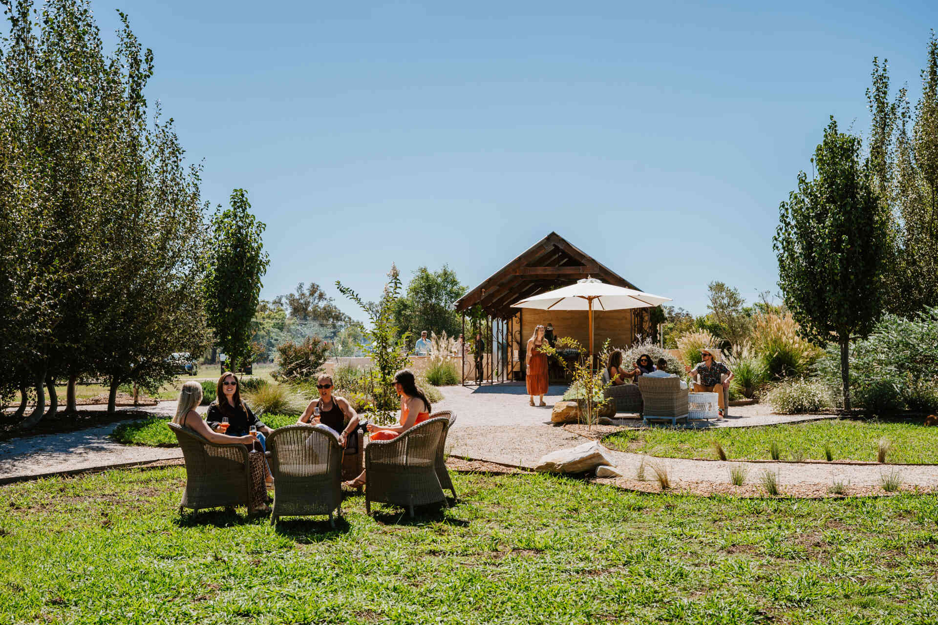 An intimate open-air events space in Australia where rammed earth, timber, and fire create a relaxed setting for gatherings and long-table dining.