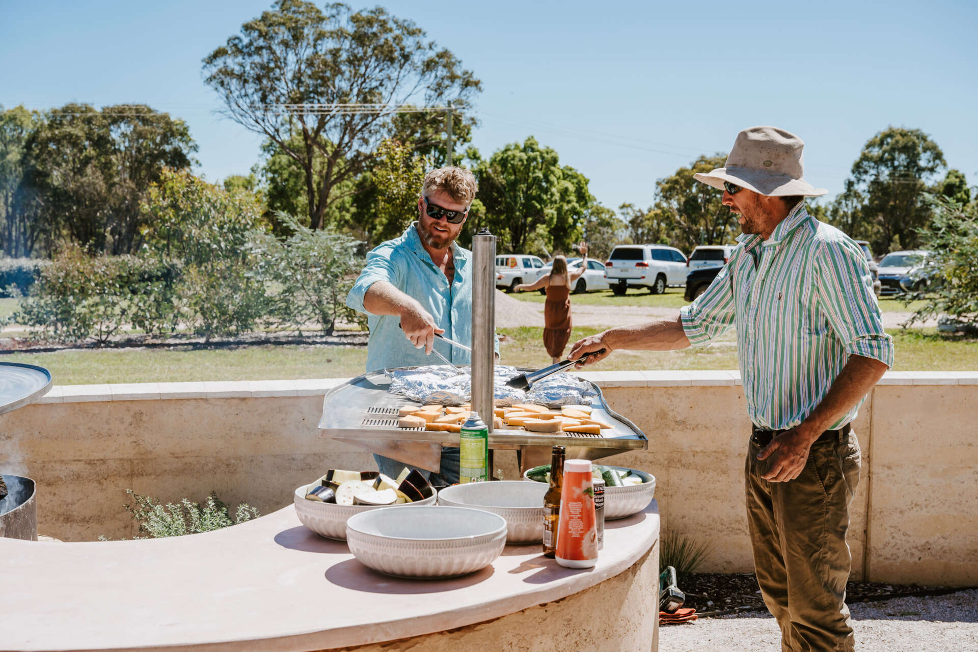 An intimate open-air events space in Australia where rammed earth, timber, and fire create a relaxed setting for gatherings and long-table dining.