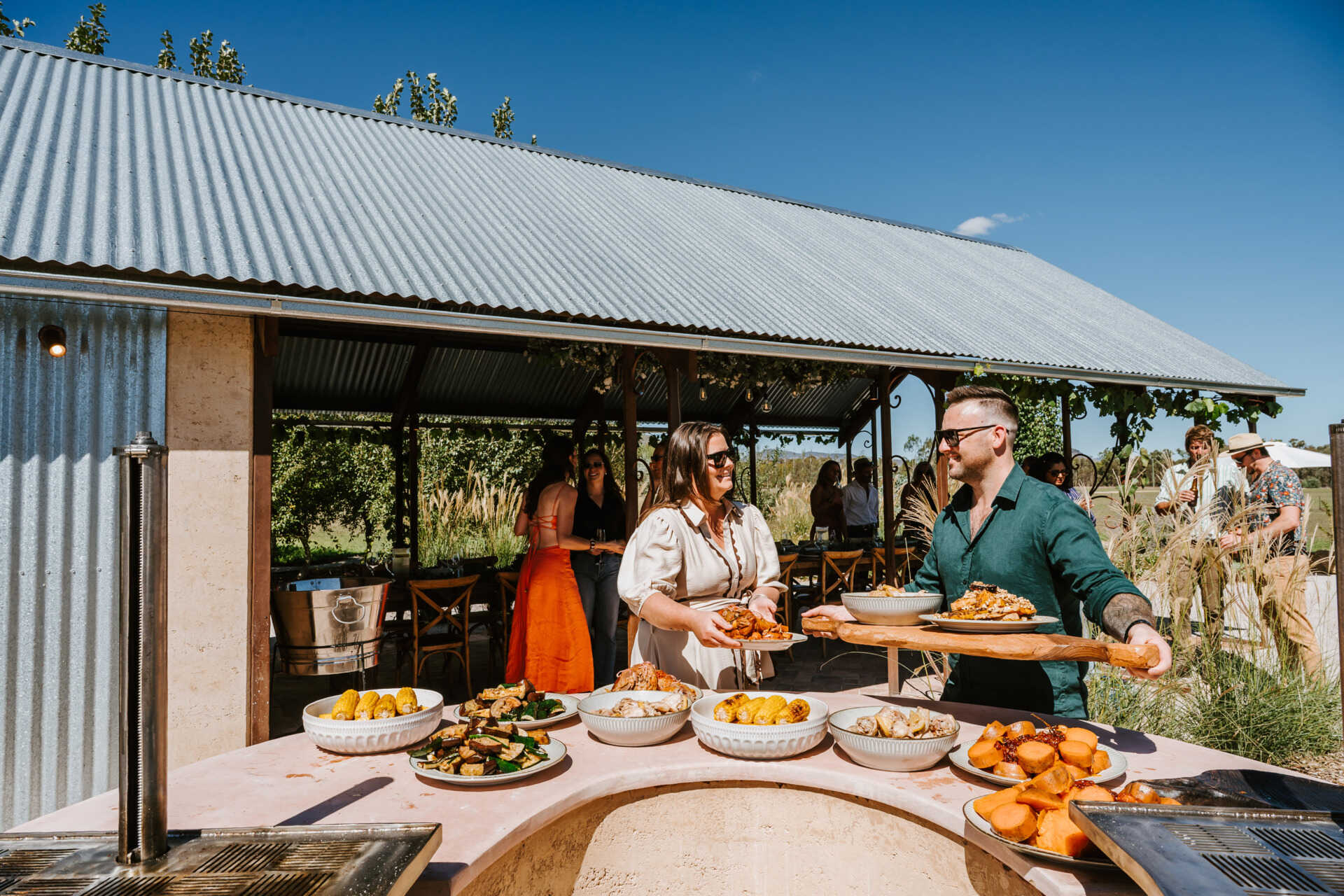 An intimate open-air events space in Australia where rammed earth, timber, and fire create a relaxed setting for gatherings and long-table dining.