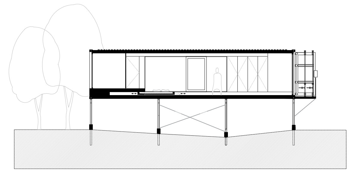 Offroadhouse in Wrzeszczyn, Poland transforms a recycled shipping container into a minimalist forest cabin with a raw industrial exterior, large deck, and peaceful natural setting beside water and dense vegetation.