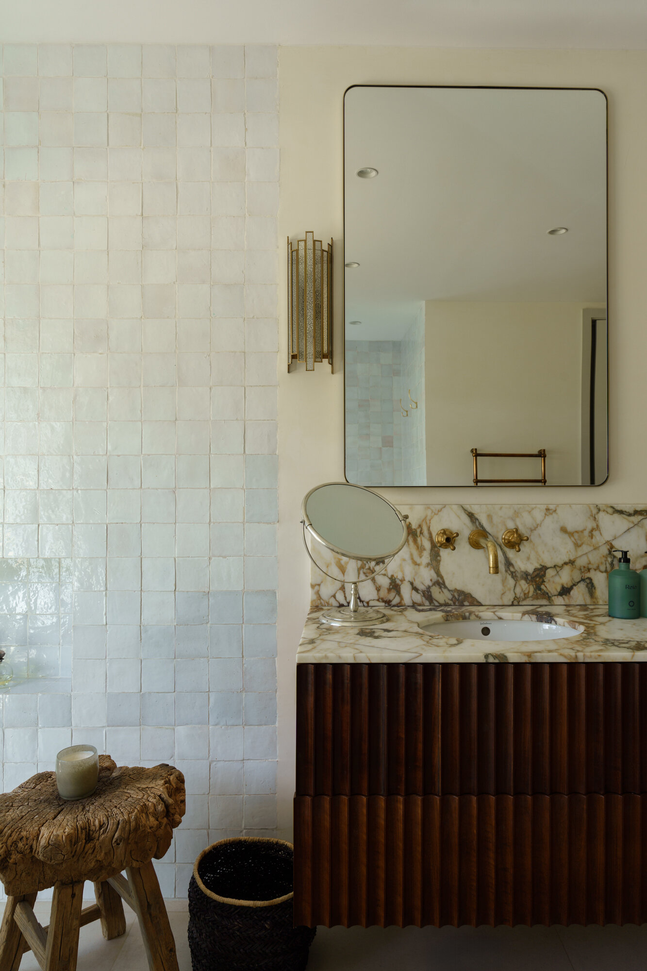 Minimalist bathrooms filled with filtered sunlight and natural textures continue the calm architectural language of this contemporary Portuguese villa.